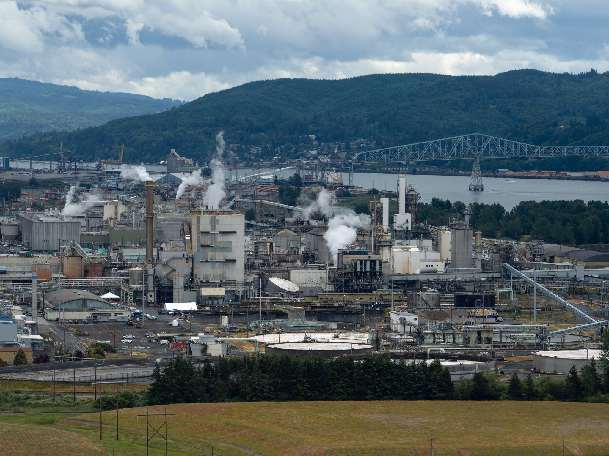A damaged chemical tank, center, is seen at the Nippon Dynawave Packaging facility in Longview on Saturday. An implosion May 26 caused a highly caustic chemical to spill, killing 11 workers at the pulp and paper mill. (Nick Wagner / The Seattle Times)