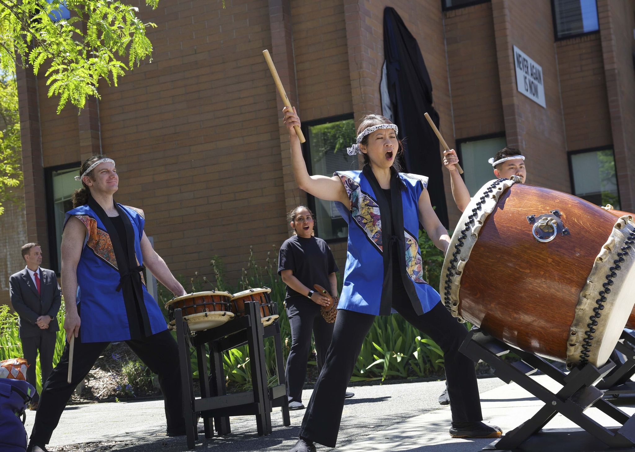 Seattle Kokon Taiko performed during the dedication ceremony marking the permanent installation of Erin Shigaki’s mural 'Never Again Is Now' at Bellevue College in Bellevue on Thursday. (Ivy Ceballo / The Seattle Times)
