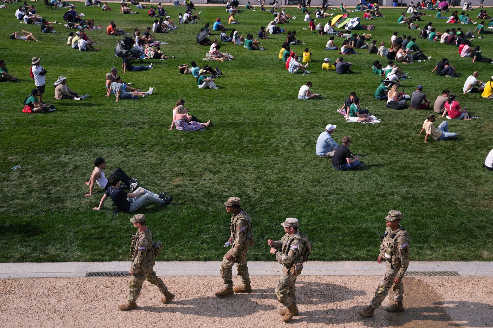 National Guard members patrol the National Mall in Washington, D.C., as fans gathered Thursday to watch the World Cup opener between Mexico and South Africa. (Allison Robbert / The Associated Press)