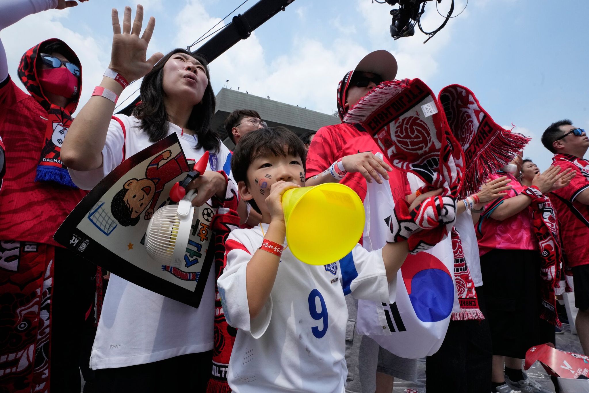 South Korean football fans at a public party in Seoul on Friday cheered for their team while watching a live broadcast of the Group A match between South Korea and the Czech Republic, played in Guadalajara, Mexico. (Ahn Young-joon / The Associated Press)