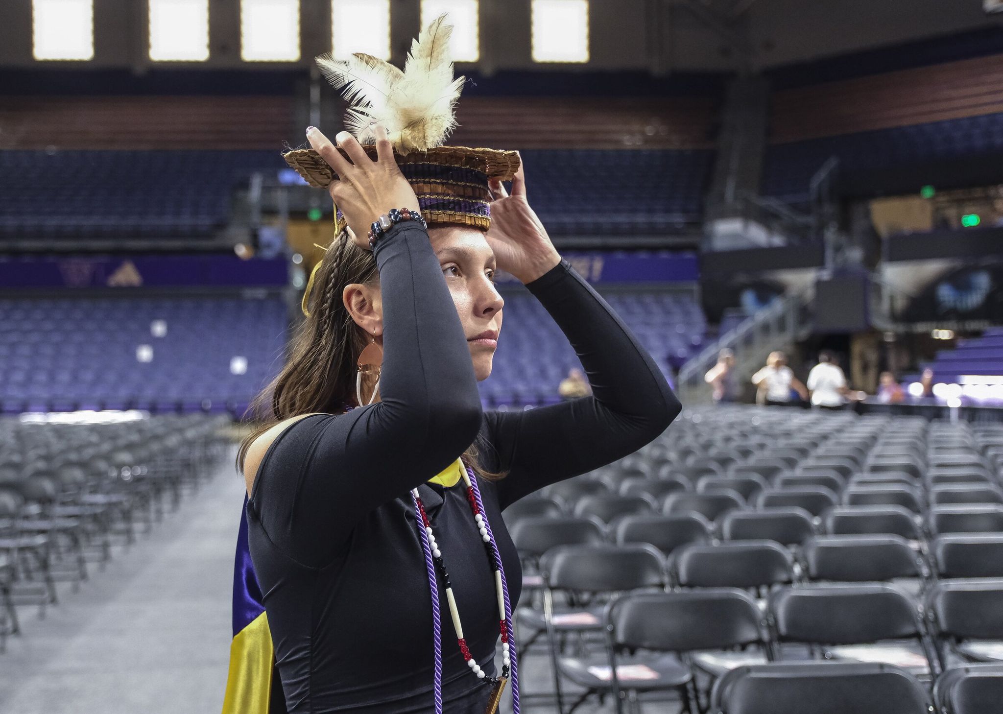Rosalie Fish holds her custom-made graduation cap on the day she received her master’s degree in social work from the University of Washington. Fish said she is grateful for the Cowlitz Tribe tuition assistance program. (Dean Rutz / The Seattle Times)