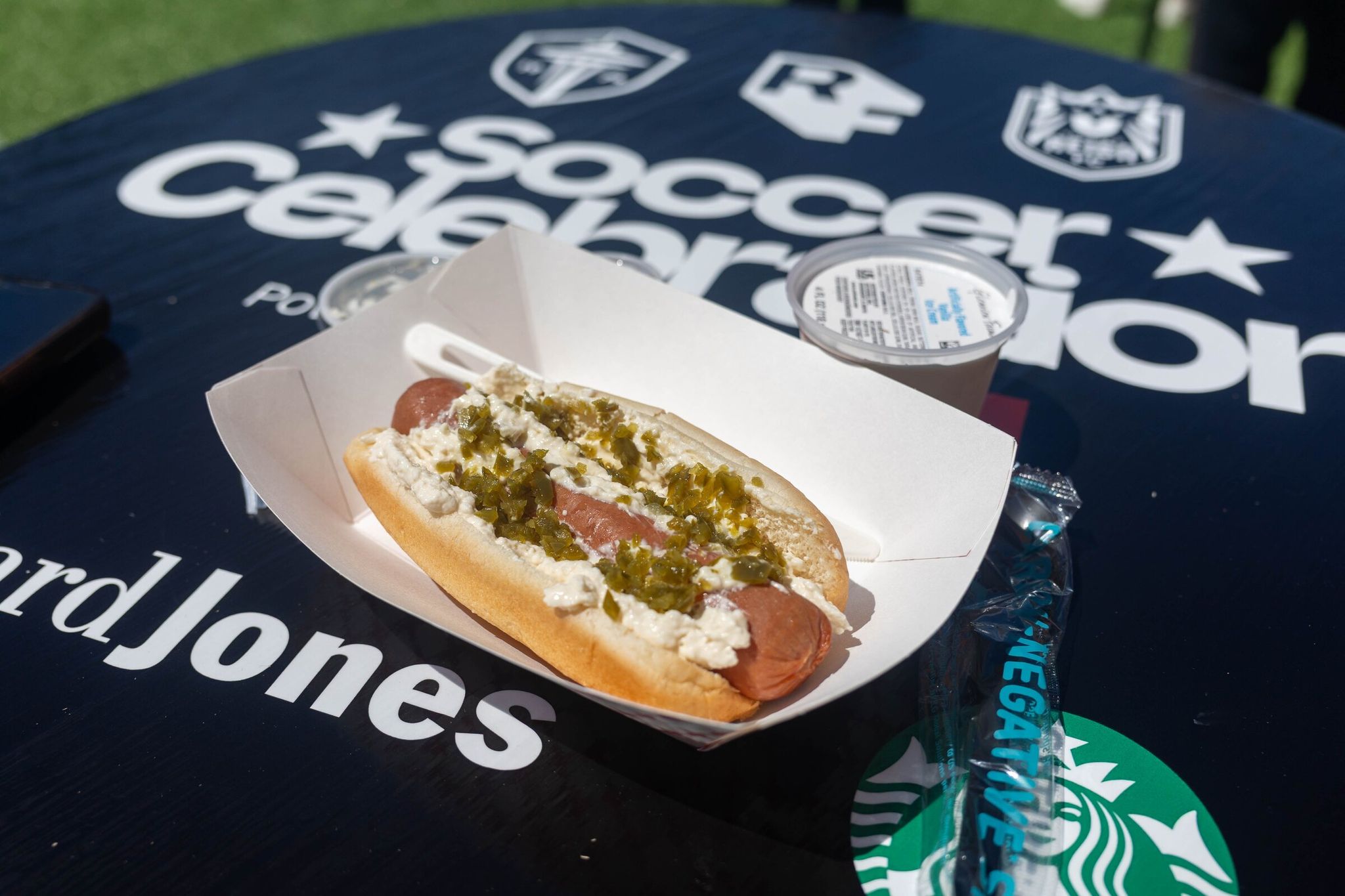 The barge kiosk serves a Seattle Dog for $14.50 and a cup of vanilla ice cream for $5. Various beers, wines, ciders and nonalcoholic drinks are also available. (Nicole Pasia / The Seattle Times)
