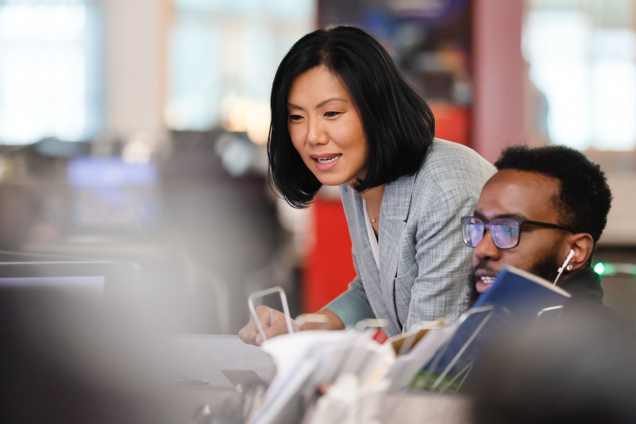 KOMO News anchor Mary Nam reviews information with news producers before an afternoon newscast in March. (Jennifer Buchanan / The Seattle Times)