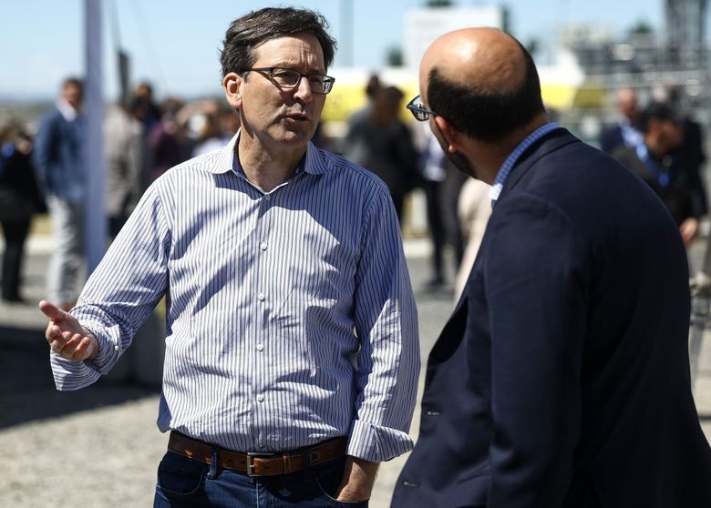 Washington Gov. Bob Ferguson chats with Ryan Spies, managing director of sustainability for Alaska Airlines, outside of Twelve’s jet fuel plant during a ribbon-cutting ceremony Wednesday in Moses Lake. (Nick Wagner / The Seattle Times)