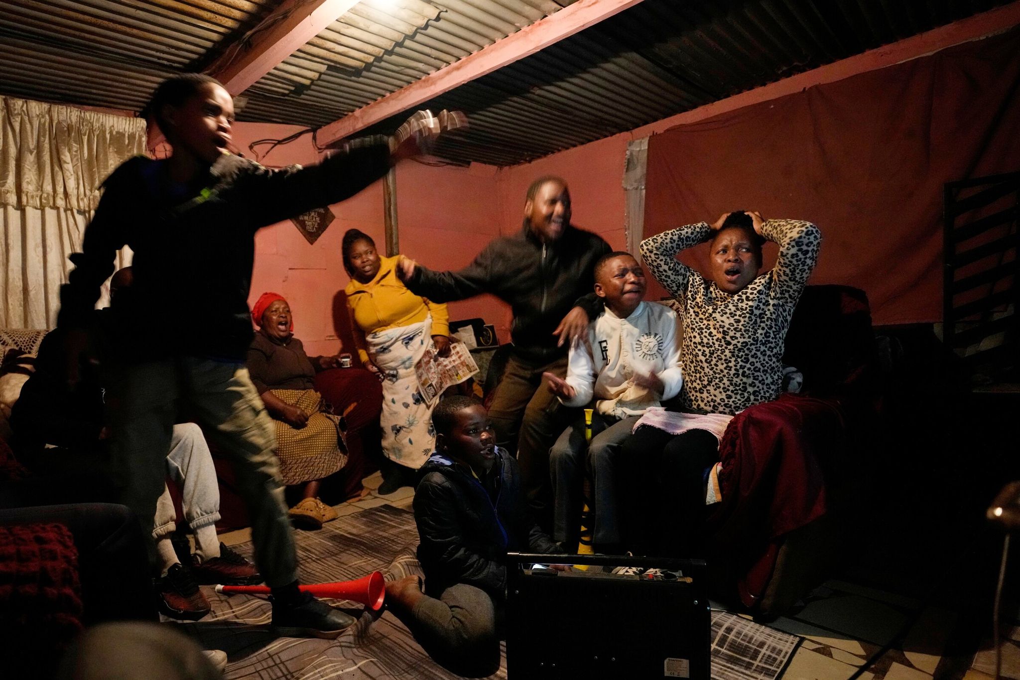 A family in Vereniging (South Africa) watches the Mexico match on Thursday, played in Mexico City. (Temba Hadebe / The Associated Press)