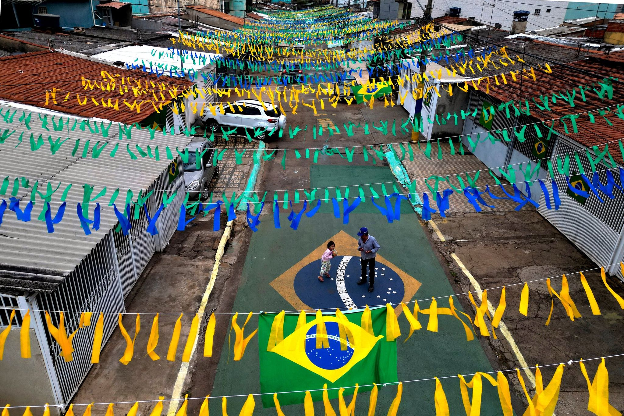 Brazilian flags wave over a street in Brasília as residents decorate the city for the World Cup on Wednesday. (Eraldo Peres / The Associated Press)