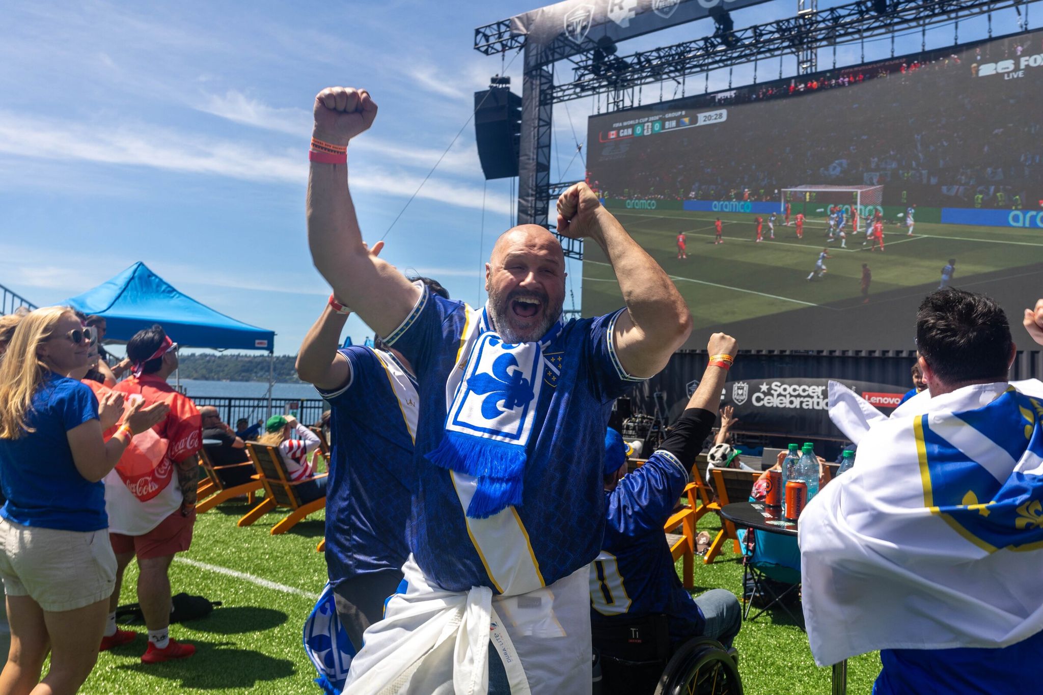 Fans of Bosnia-Herzegovina cheer after their team scored the opening goal in a World Cup match against Canada on June 12. The Seattle Soccer Celebration is a barge floating on Elliott Bay throughout the World Cup. (Nicole Pasia / The Seattle Times)
