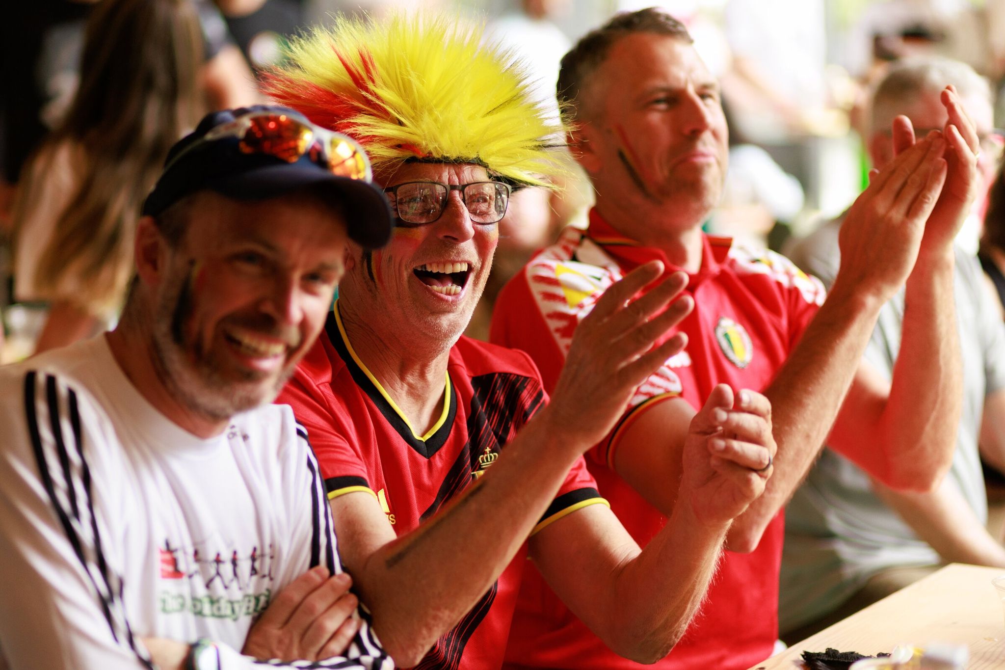 Belgian fans, including Mario Schmit, left — Chris Fuber and Jesse Buttler — watch Monday’s match against Egypt at Lowlander Brewing near Lumen Field, known as Seattle Stadium during the World Cup. (Erika Schultz / The Seattle Times)