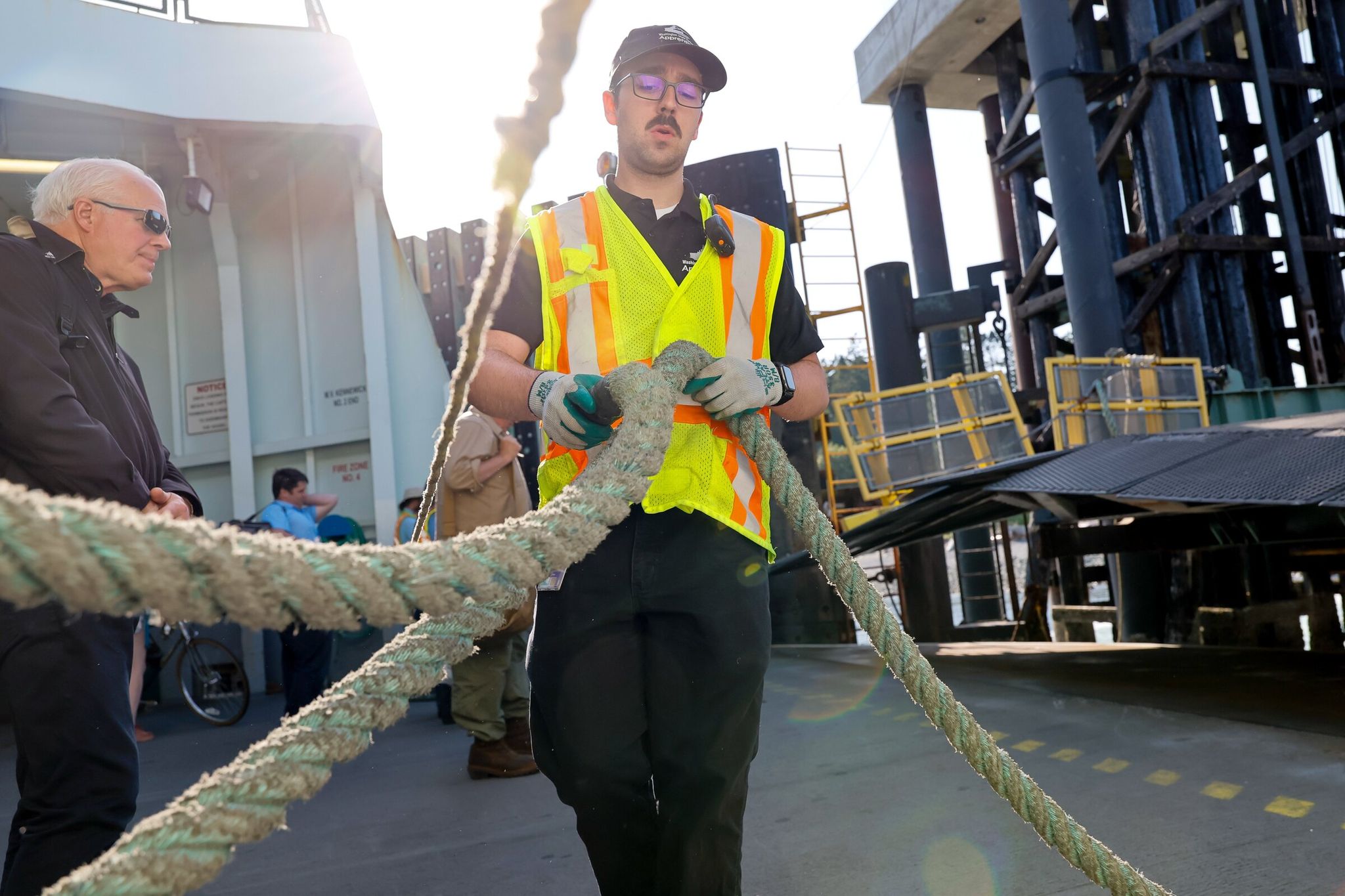 Apprentice Adam Knutsen flips a rope onto a cleat on the ferry Kennewick as it docks at Keystone. Apprenticeships are booming in Washington. (Jennifer Buchanan / The Seattle Times, 2025)