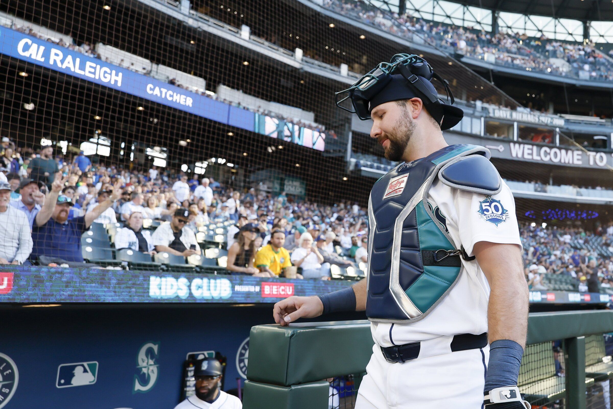 Seattle Mariners catcher Cal Raleigh presents to the fans as he returns to the dugout before the start of his first game after returning on Tuesday, June 16, 2026, in Seattle. (Jennifer Buchanan / The Seattle Times)
