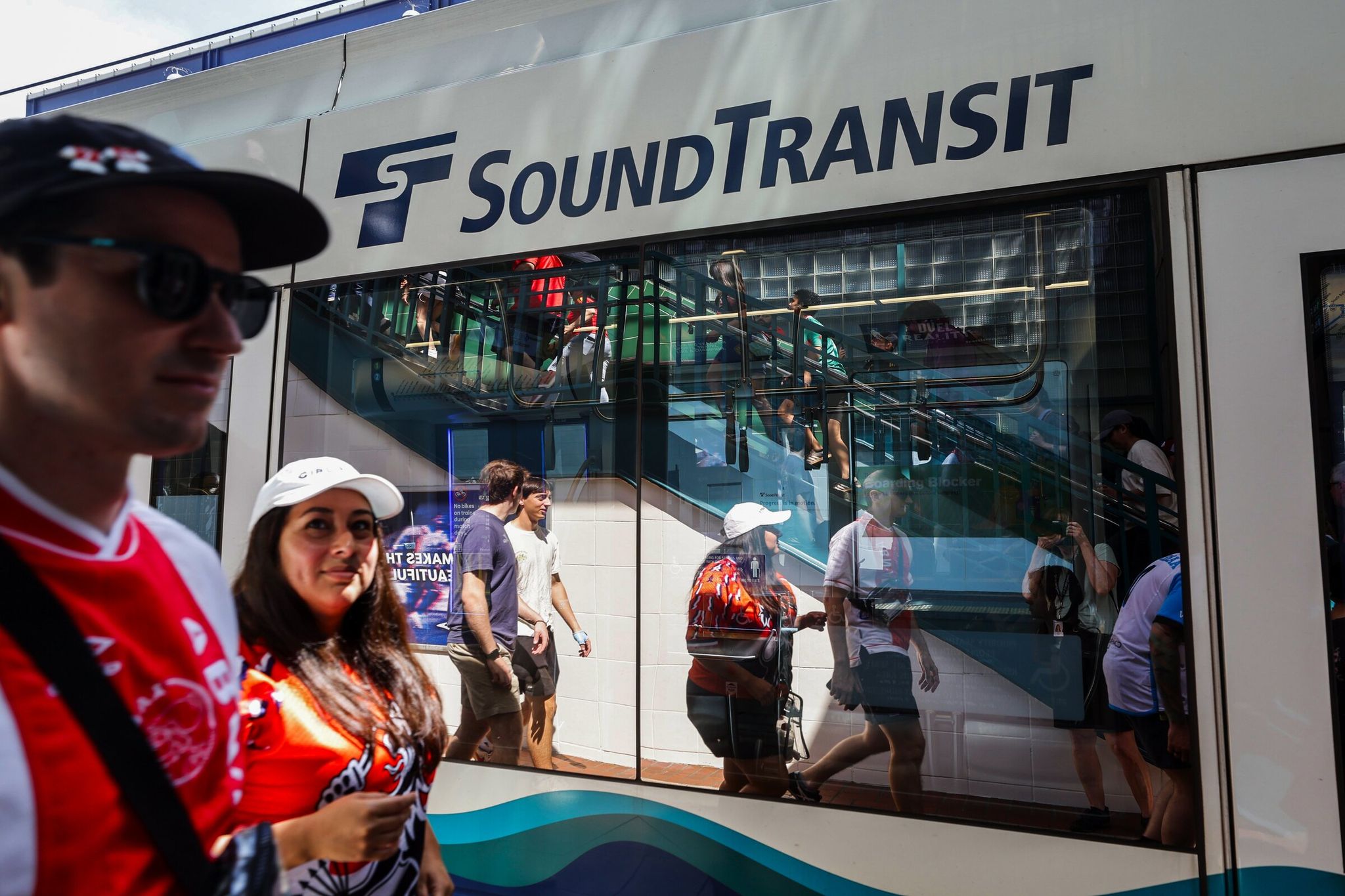 Soccer fans disembark at International District/Chinatown Station and head to Seattle Stadium before Belgium vs. Egypt World Cup match Monday. Light rail carried an estimated 210,000 passengers Monday, the third-highest volume ever, said spokesperson Henry Bendon. (Karen Ducey / The Seattle Times)