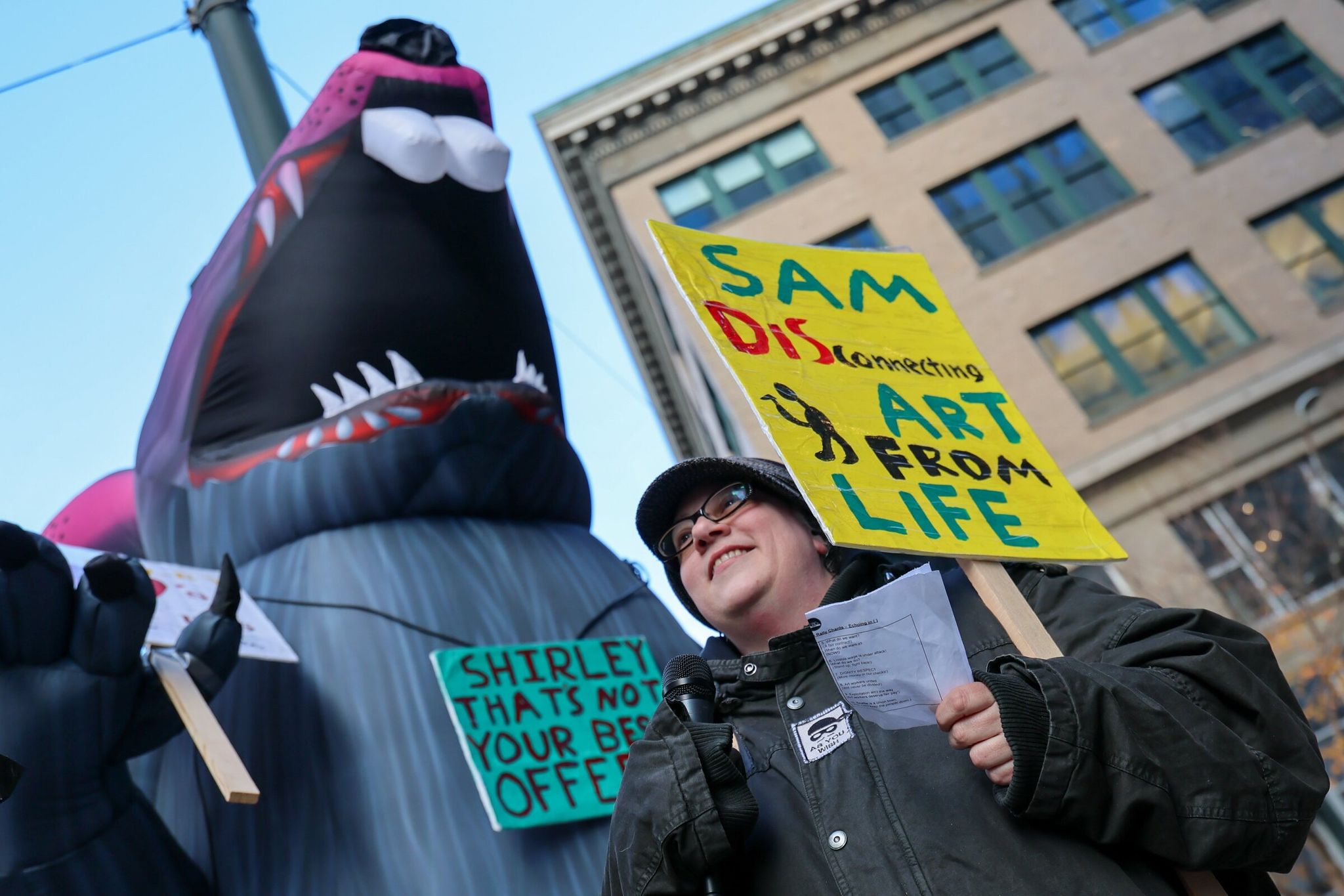 Willow Enright leads a chant supporting the striking Seattle Art Museum Visitor Service Officer Union in front of Seattle Art Museum. A separate union representing other SAM employees officially organized this week with a successful unionization vote. (Kevin Clark / The Seattle Times, 2024)