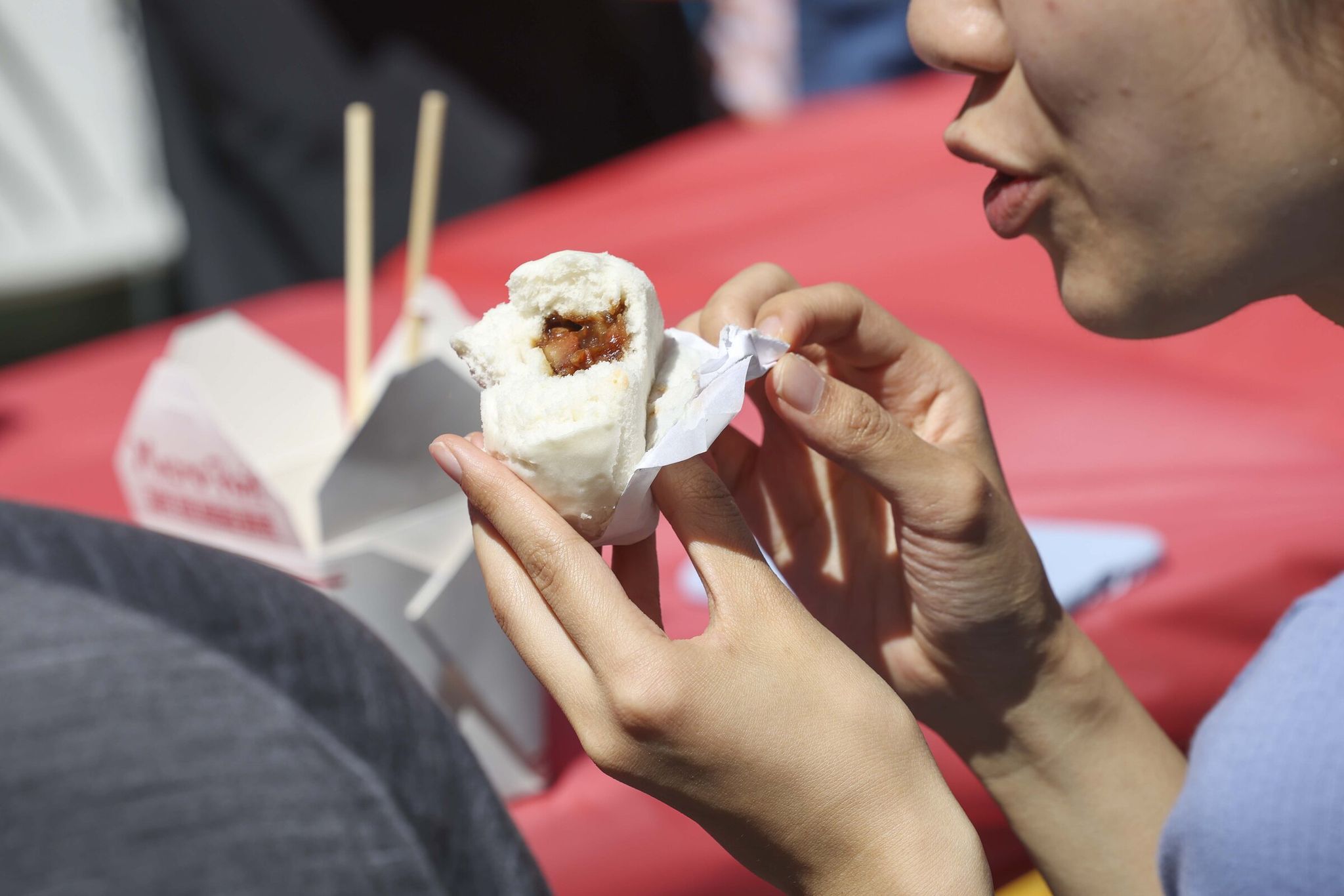 Participants join the attempt to break the Guinness record for the largest dim sum meal at a summer kickoff block party in the Chinatown International District on Thursday. (Ivy Sèballo / The Seattle Times)