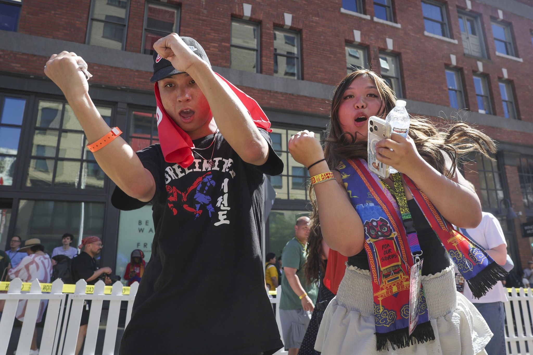 Daryan Sechao, left, and Eliana Le celebrate that Seattle set the Guinness record for the world’s biggest dim sum lunch on Thursday. (Ivy Sibil lo / The Seattle Times)