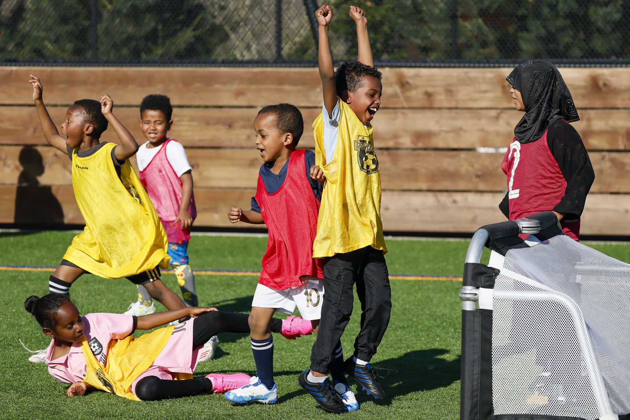A yellow team celebrates a goal on the U-7 field during a 3×3 soccer tournament in Seattle (SeaTac). (Jennifer Buchanan / The Seattle Times)