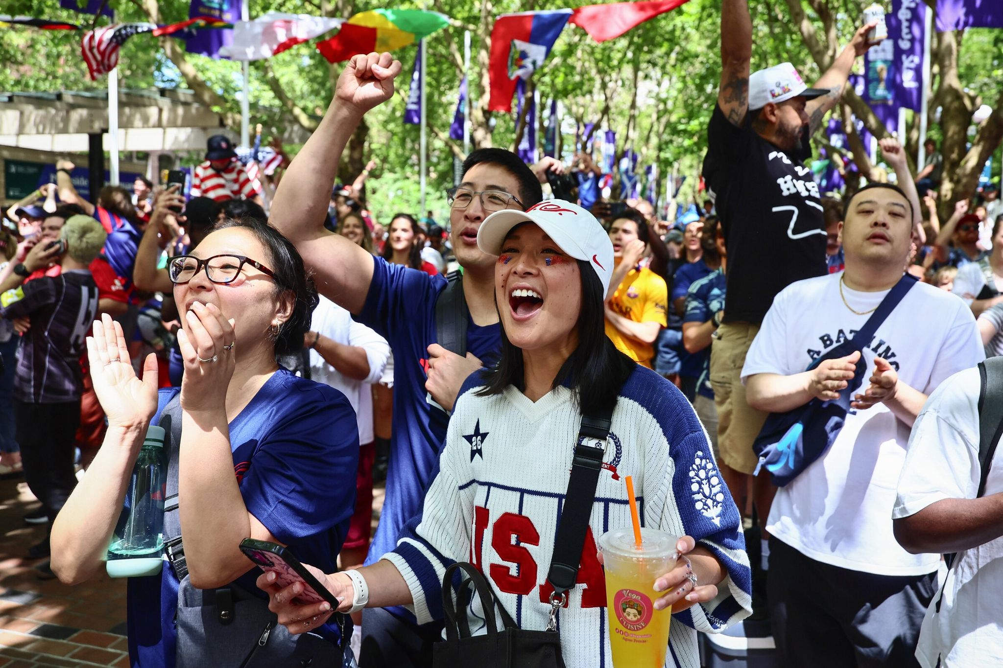 Fans cheer from Occidental Park as the U.S. men’s team scores a second goal during their World Cup match against Australia in Seattle on Friday. (Kevin Clark / The Seattle Times)