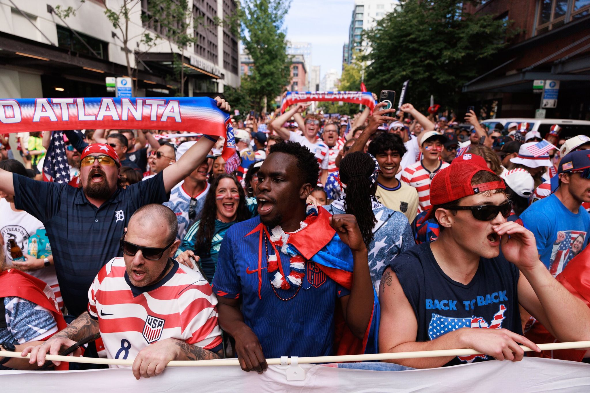 Alvin Kamau in the center wearing a blue uniform walks toward the U.S. World Cup match—Australia in Seattle on Friday. (Erika Schultz / The Seattle Times)