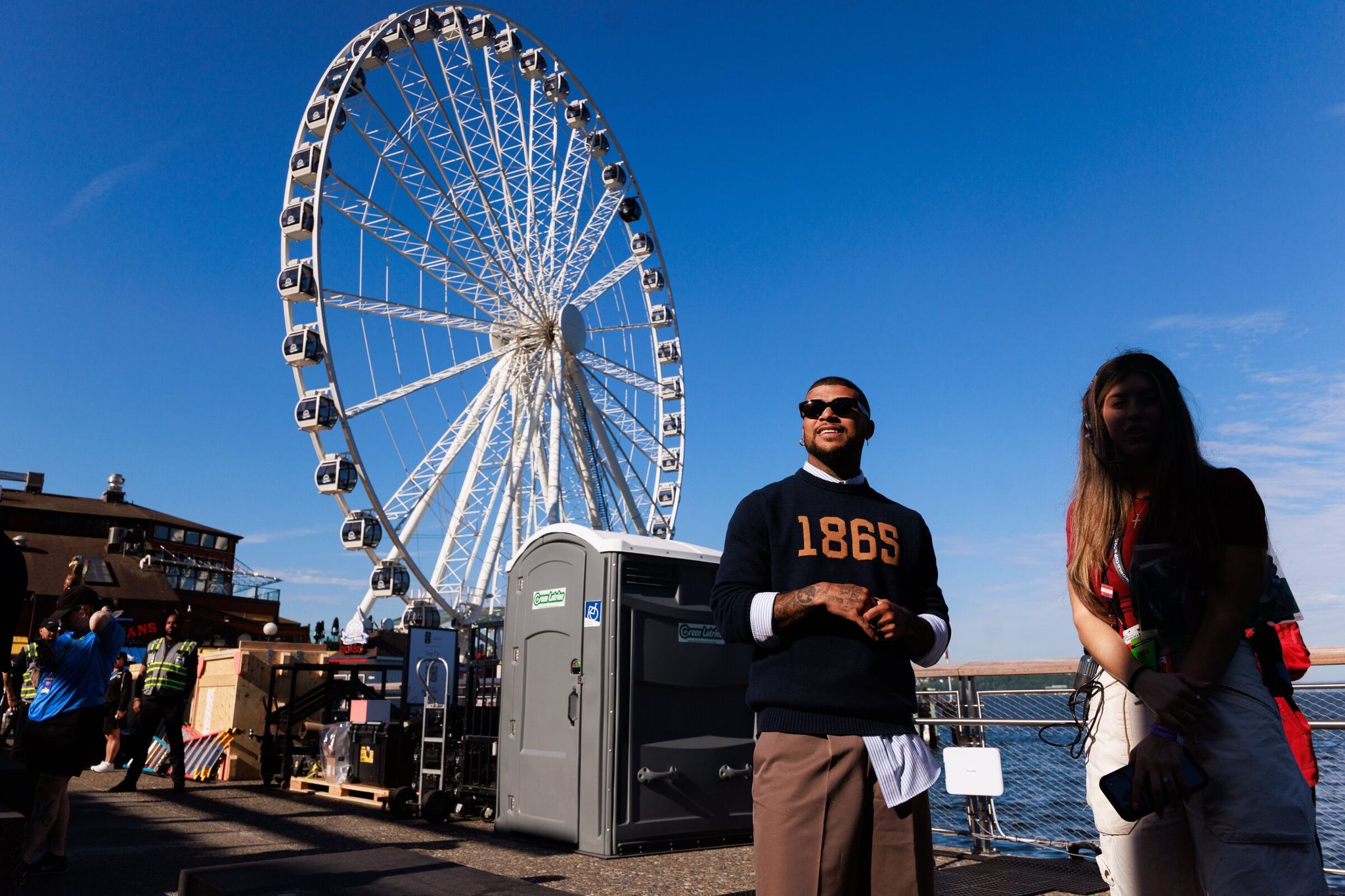DeAndre Yedlin prepares to join the “Men in Blazers” live podcast recording on Pier 58 in Seattle on Friday. The pier hosted a Juneteenth event before the U.S. vs. Australia World Cup match. (Erika Schultz / The Seattle Times)