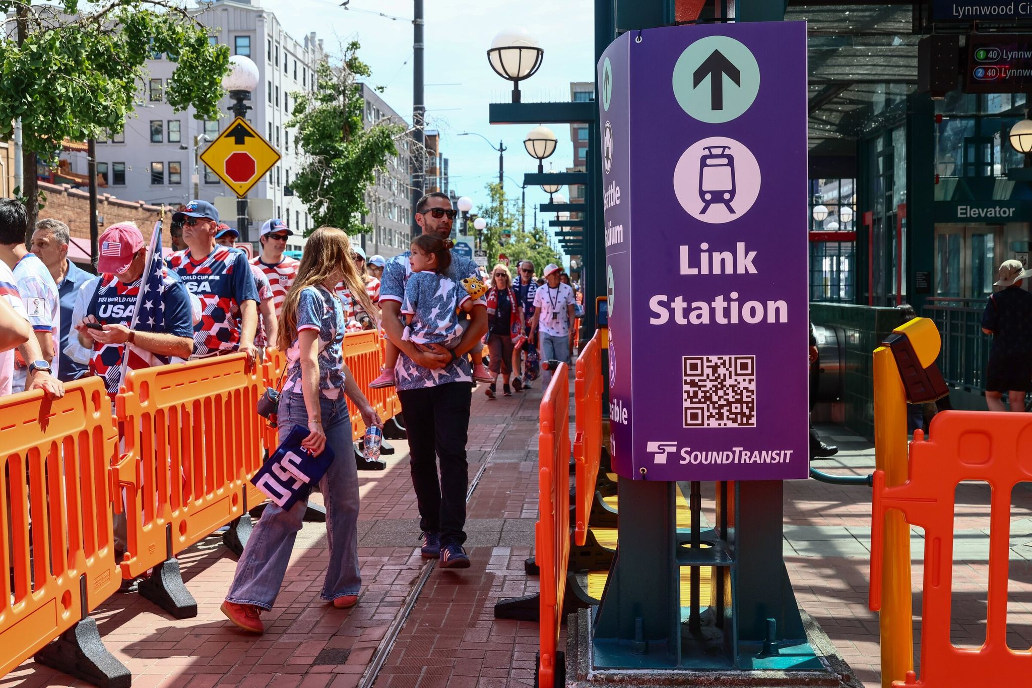 Fans line up to board light rail at the Chinatown/International District station after the World Cup match between the United States and Australia on June 19, 2026 in Seattle. (Kevin Clark / The Seattle Times)
