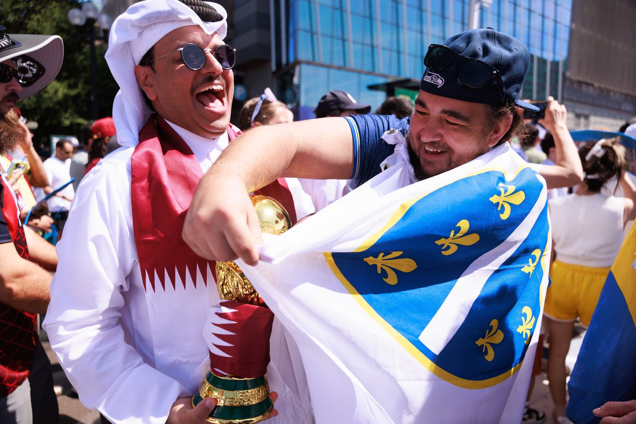 Mohammed Alshamari of Qatar, left, takes a photo with a fan from Bosnia and Herzegovina before their teams met on the field at Lumen Field as part of the World Cup. (Erika Schultz / The Seattle Times)