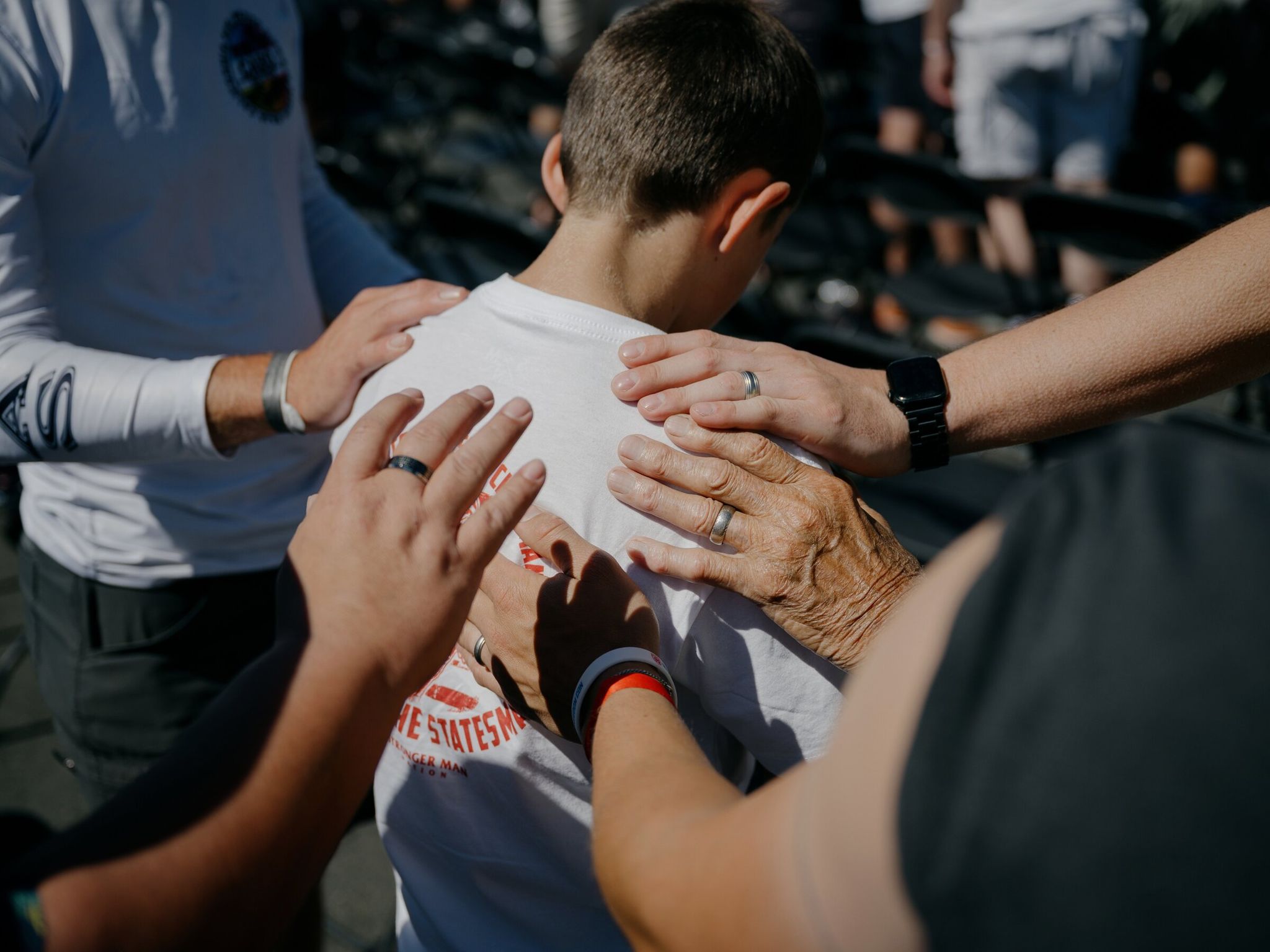 A young boy is prayed over during Freedom Con at the Gorge Amphitheatre outside the town of George, Washington, on June 20. (Grant Hindsley / The New York Times)