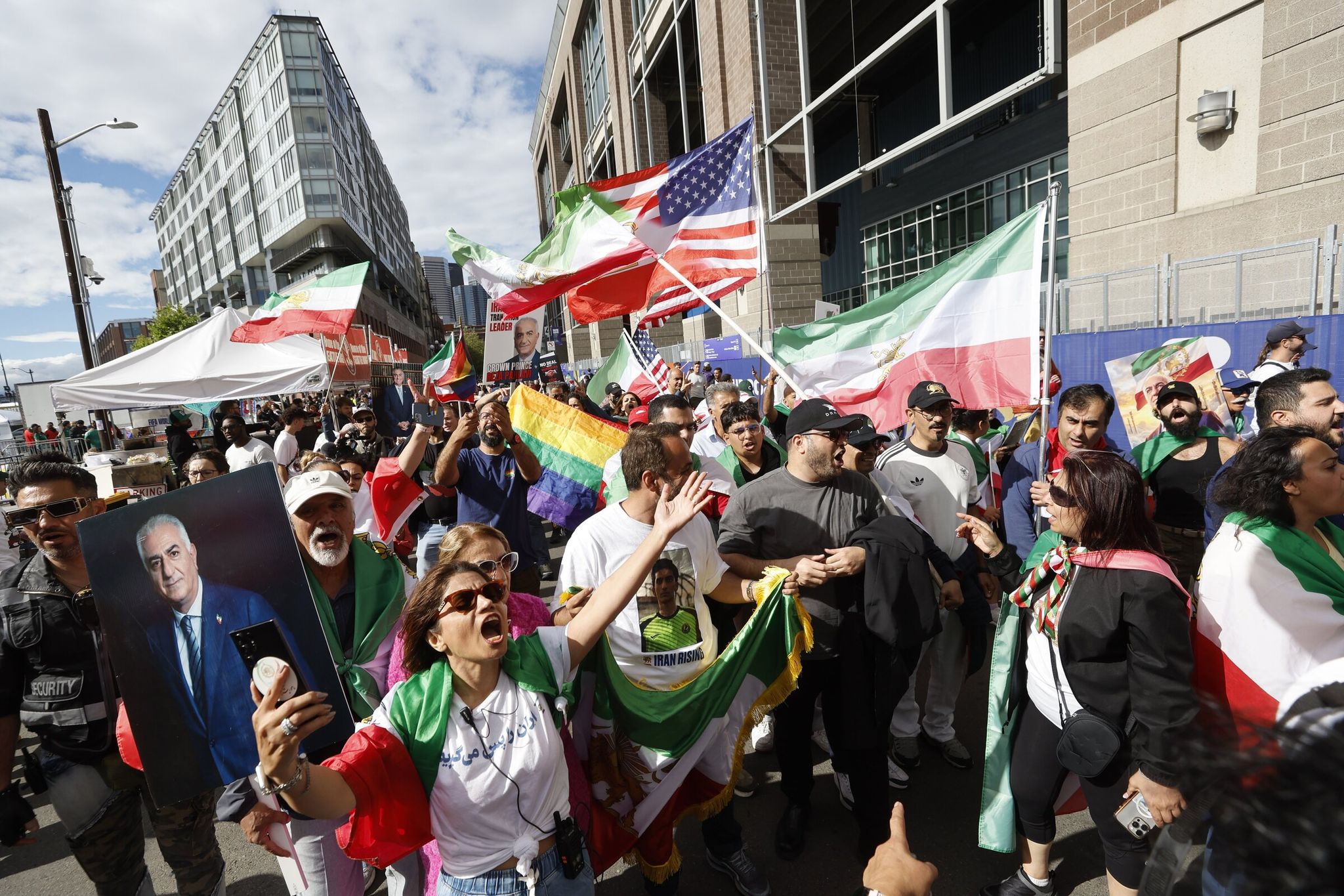 Protesters chant “Hey hey Ho Ho, ayatollah’s got to go!” referring to the current leadership of Iran as they march outside Seattle Stadium before the World Cup Group G soccer match between Egypt and Iran Friday in Seattle. (Karen Ducey / The Seattle Times)