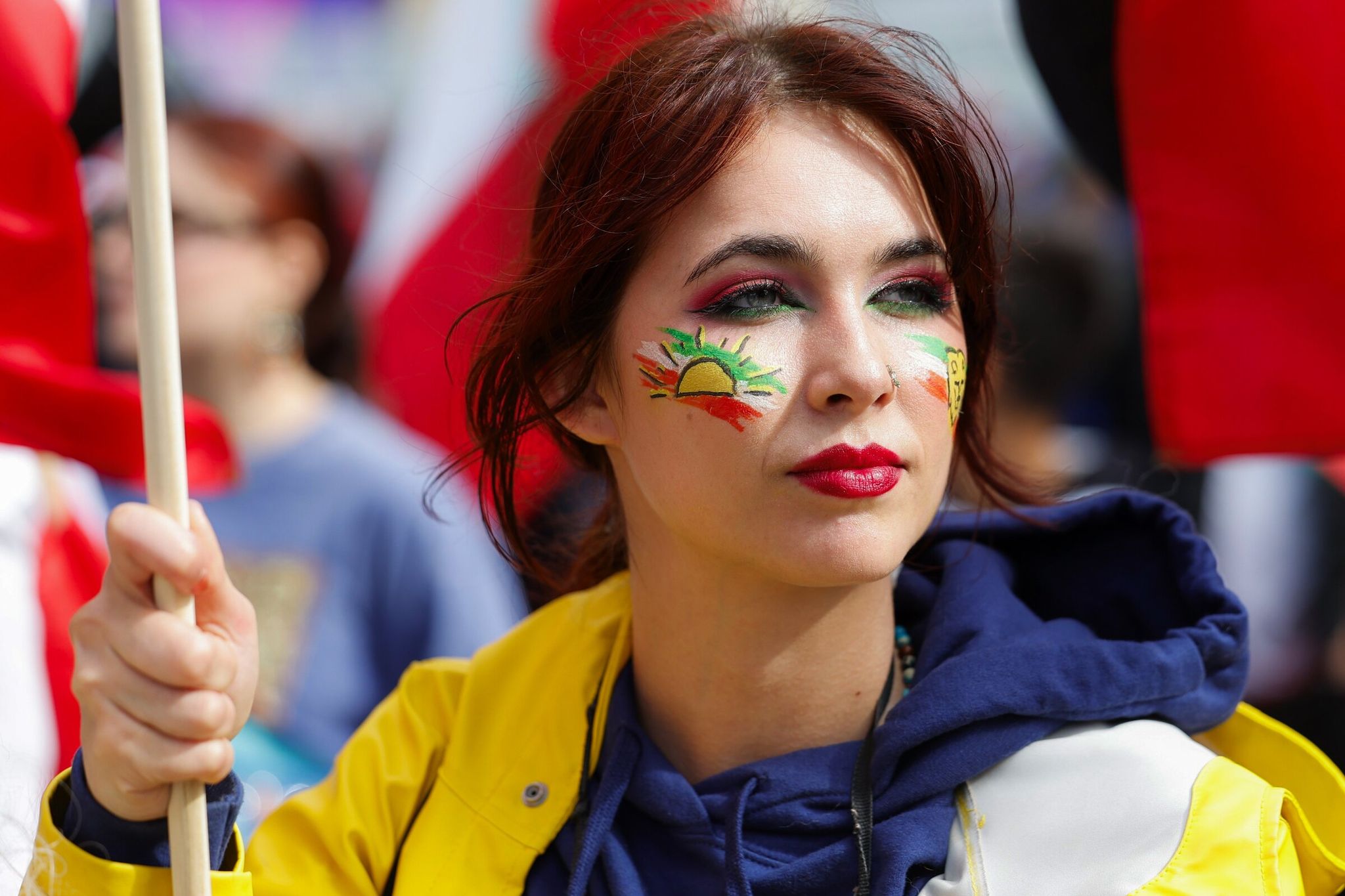 Seattle’s Kamala Harris passes a stadium while showing support for the Iranian people, with a lion and sun on her face, as protesters and soccer fans gathered at Pioneer Square before Iran played Egypt in the group-stage match on Friday. (Karen Dusi / The Seattle Times)