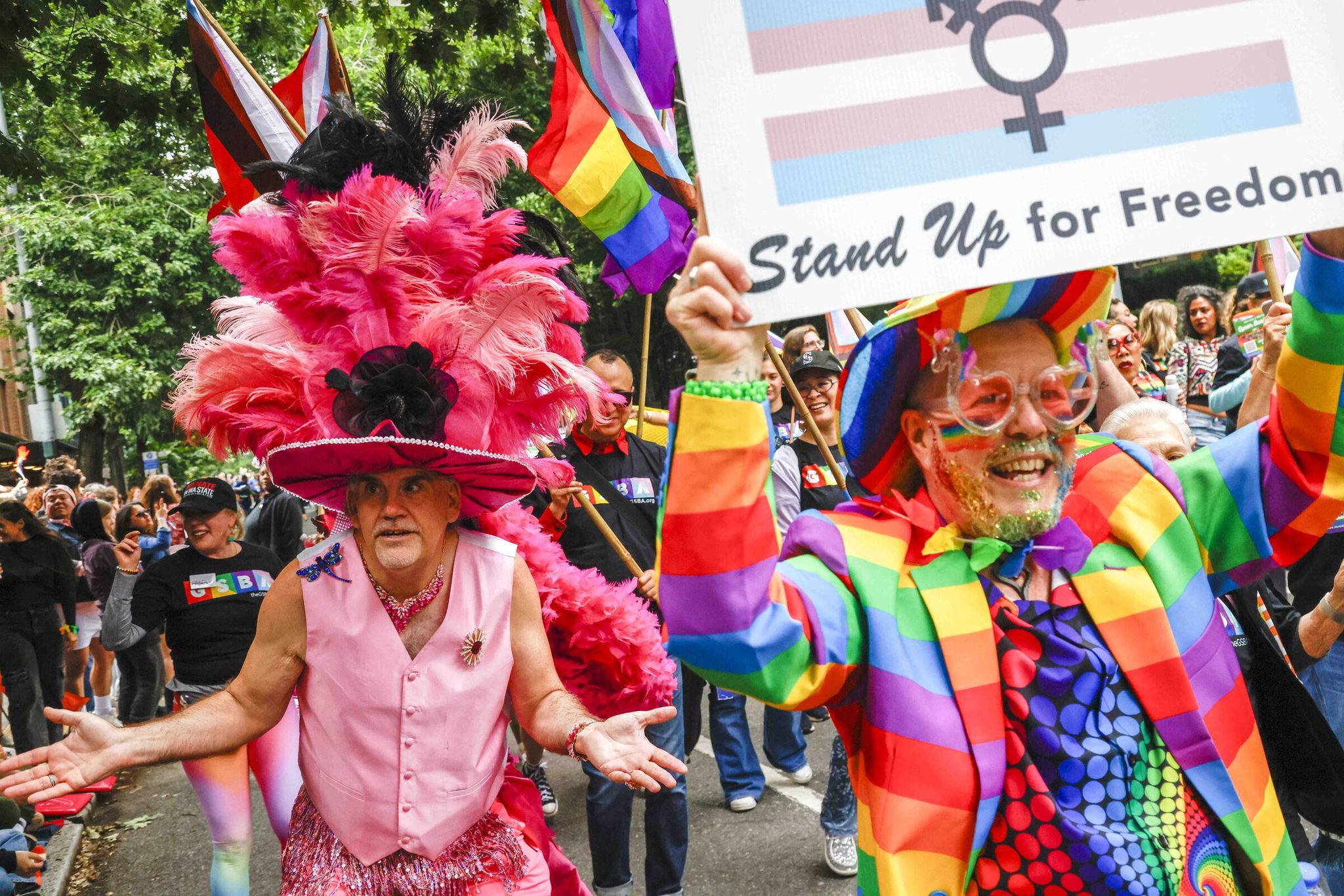 Troy Coleman (left), performing under the stage name Sparkles Pancake, gathers spectators at the annual Pride Parade in downtown Seattle on Sunday. (Andrew Burke-Stevenson / The Seattle Times)