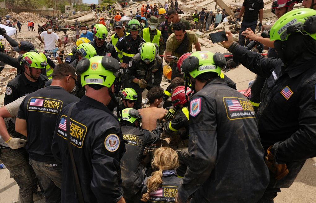 After a tap heard in rubble, U.S. rescue teams begin a grueling marathon