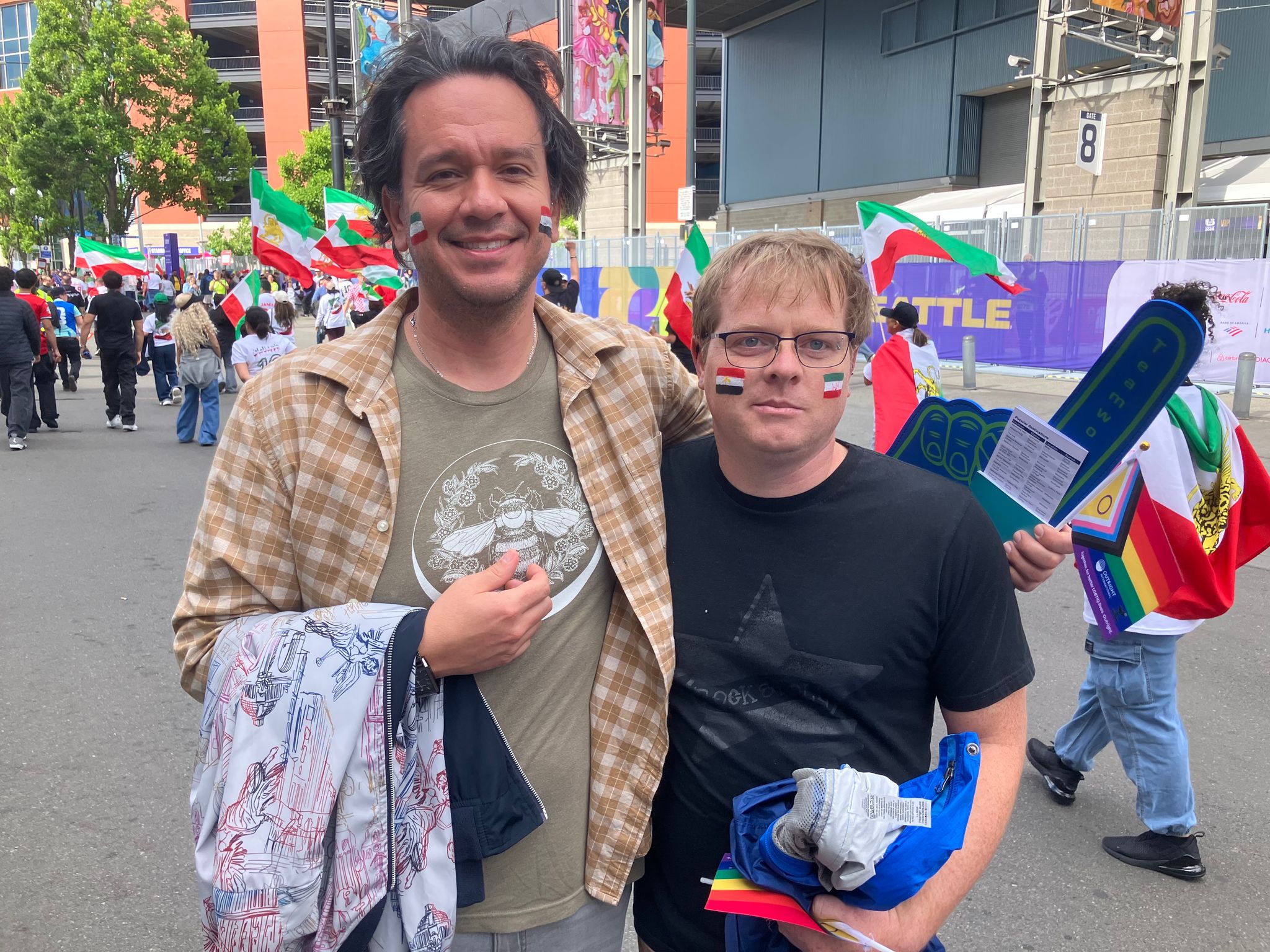 Tim Parker (right) and Danny Torres show support for both teams and welcome Seattle’s designation as a “Pride Match” ahead of the World Cup match at Seattle Stadium on Friday. (Daniel Bikman / The Seattle Times)