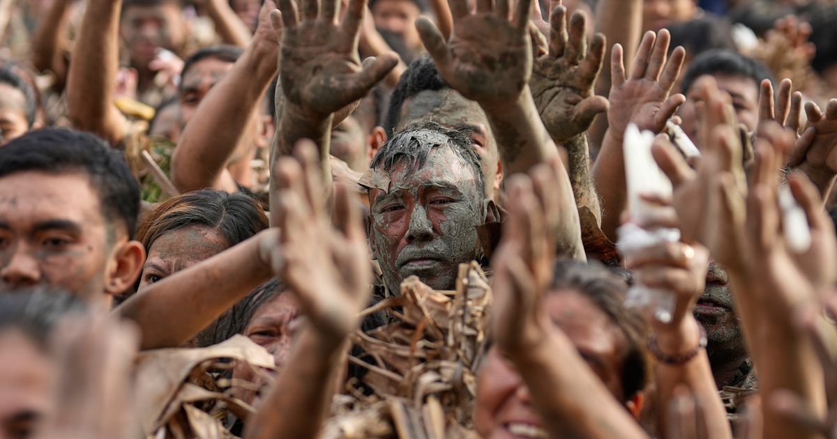 Philippine devotees honor St. John the Baptist with a mud-covered display of faith