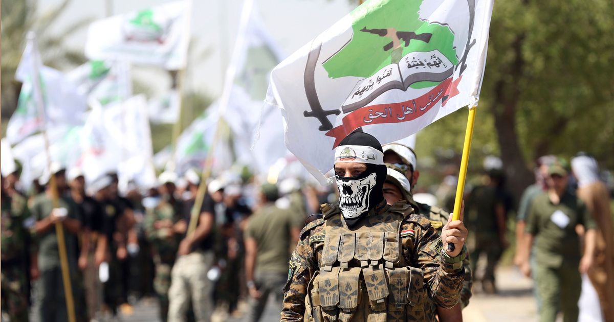 Powerful Iran-backed Iraqi militia says it will start handing its weapons to the state