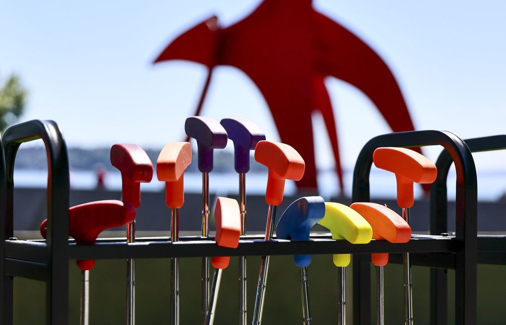 Putters await golfers at Olympic Sculpture Park on Seattle’s waterfront. In the background is Alexander Calder’s “Eagle” sculpture. (Kevin Clark / The Seattle Times)