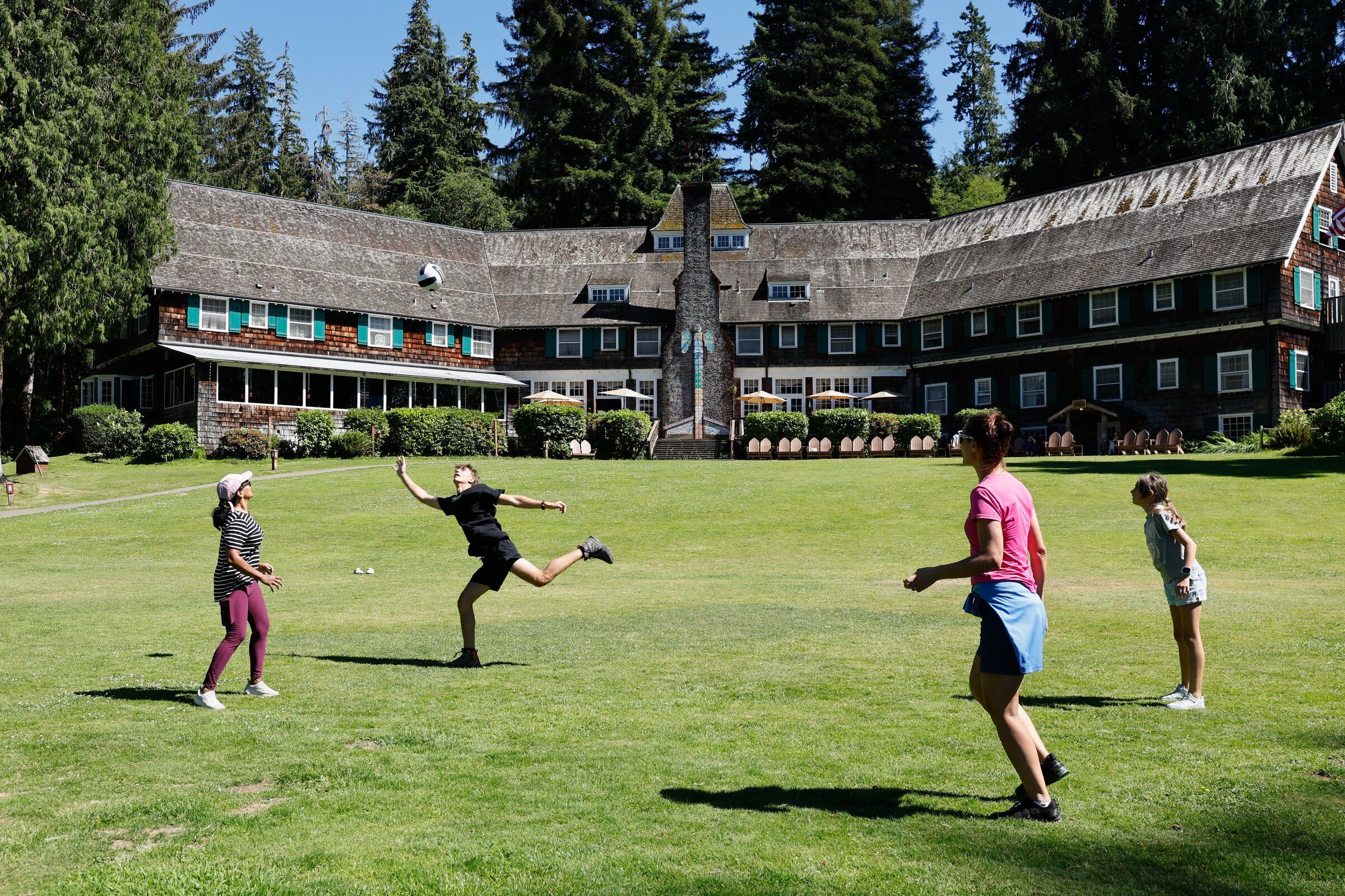 At 100 years old, Lake Quinault Lodge is still a lot of fun. On the lawn, from left to right: Suseela Panguluri, from Redmond; Zachary Simut, his mother Daniella Simut and sister Victoria Simut, all from Naples, Fla. (Karen Ducey / The Seattle Times)