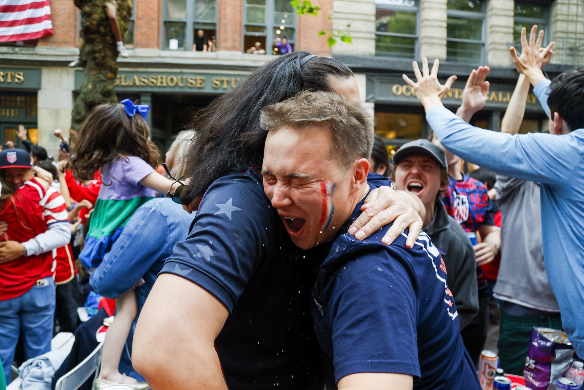 Jonathan James, right, hugs Kurt Pritchard, James’s best friend’s older brother, after the US team scored a goal in the first half at a watch party for the United States vs. Bosnia-Herzegovina FIFA World Cup Round of 32 match on the evening of Wednesday, July 1, 2026 in Seattle. (Andrew Burke-Stevenson / The Seattle Times)