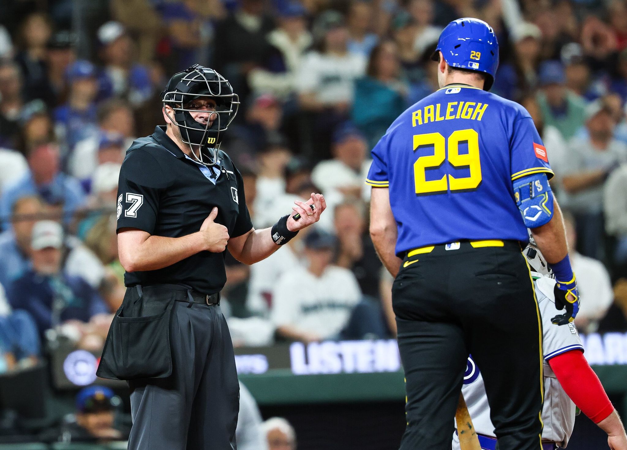 Cal Raleigh has words with home plate umpire Paul Clemons after a called strike two in the ninth. Raleigh would strike out in the at-bat. (Dean Rutz / The Seattle Times)