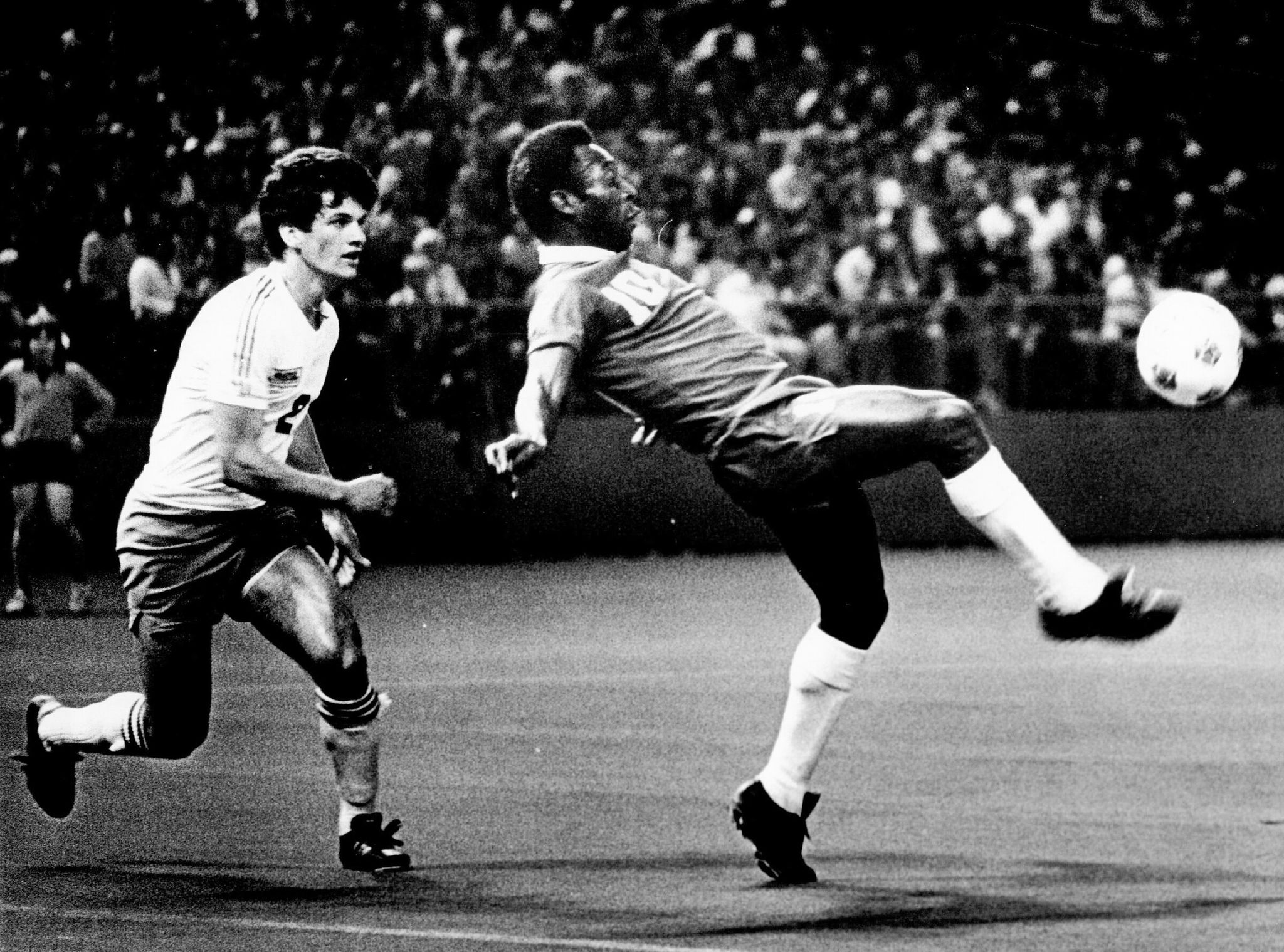 In April 1976, New York superstar Pele delivered his famous toe tap to the ball and ended up on the artificial turf. Following the ball was Seattle player Dave D’Errico (2). (Greg Gilbert / The Seattle Times)