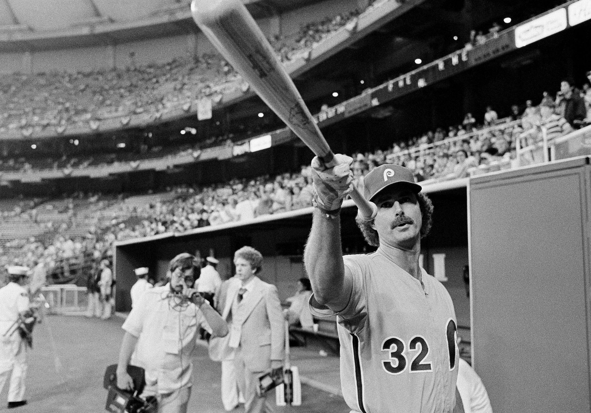 Philadelphia Phillies pitcher Steve Carlton, who will start for the National League in All Star game at Seattle, July 17, 1979, looks over a bat prior to the start of the game. (The Associated Press)