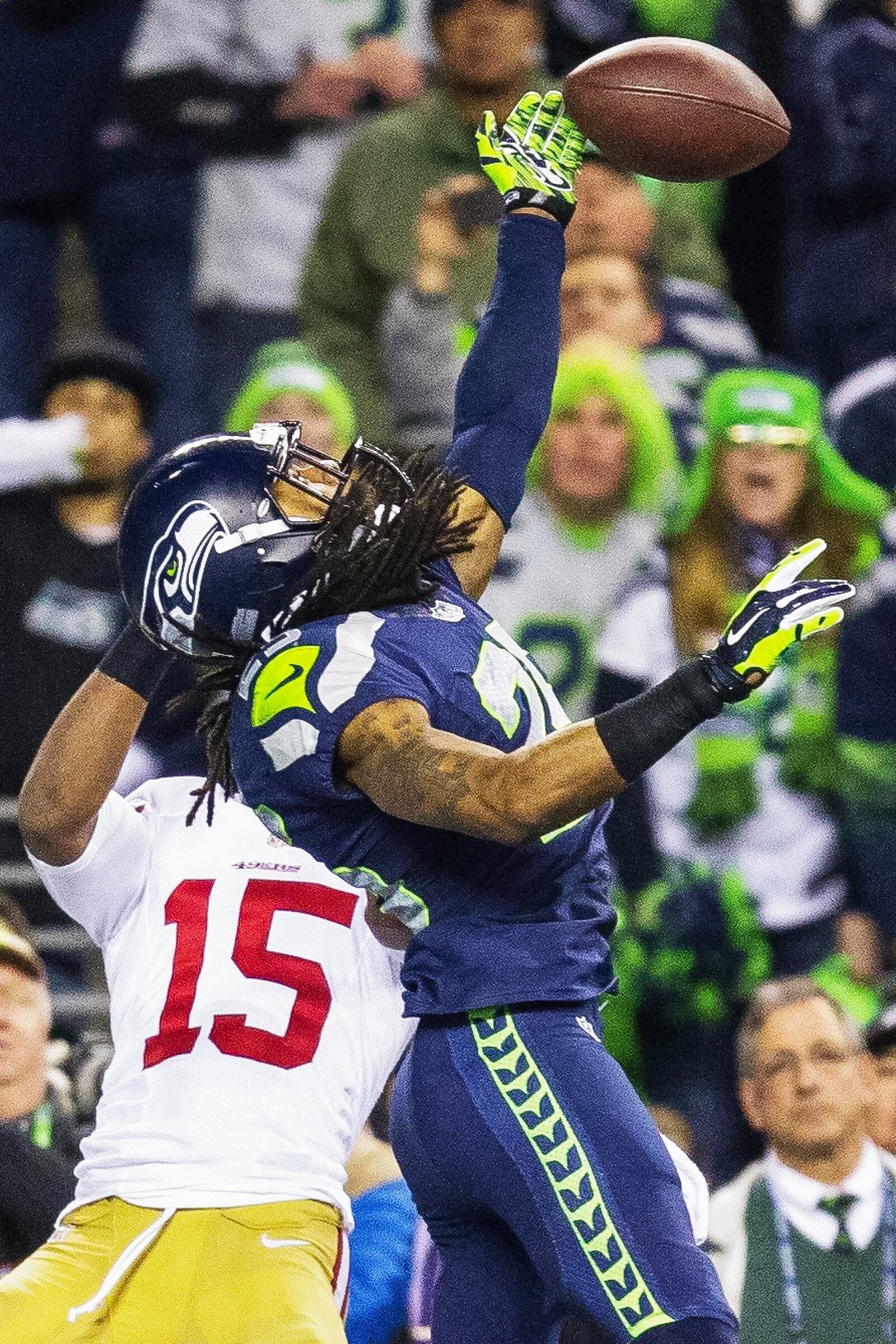 Seattle cornerback Richard Sherman deflects a ball in the end zone, intercepted by Malcolm Smith, securing a 23–17 victory over the San Francisco 49ers in the NFC Championship game on Sunday, January 19, 2014, in Seattle. (Dean Rutz / The Seattle Times)