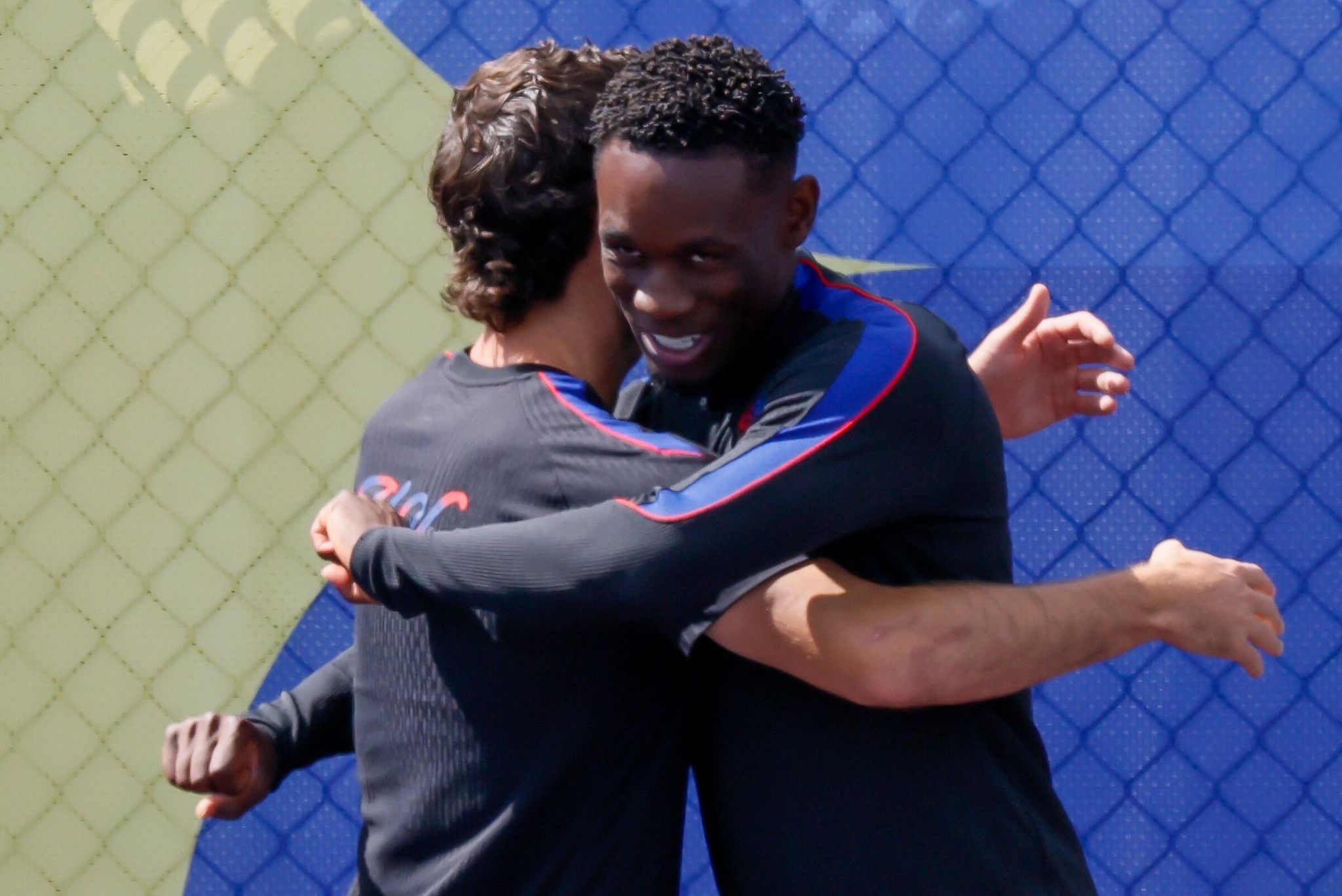 U.S. men’s national team forward Christian Pulisic, left, greets Folarin Balogun before training on Sunday. (Jennifer Buchanan / The Seattle Times)