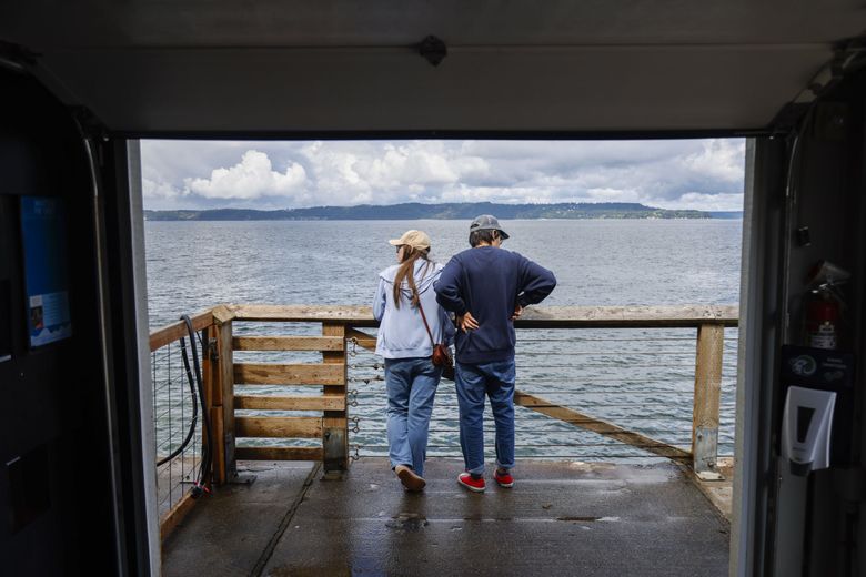 Visitors look out over the pier just outside the aquarium at the MaST Center Aquarium on Redondo Beach in Des Moines. (Andrew Burke-Stevenson / The Seattle Times)