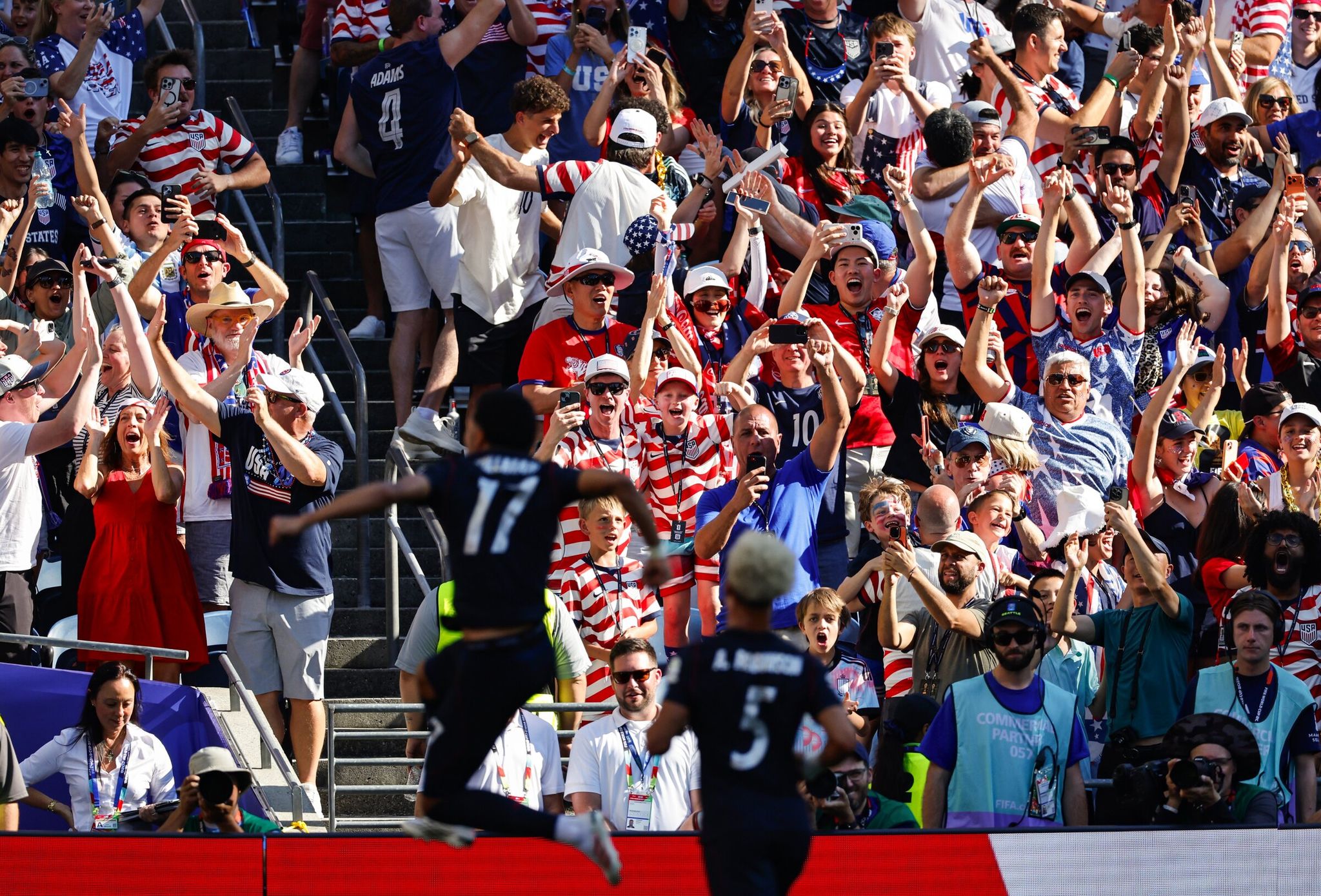 Fans celebrate as U.S. midfielder Malik Tillman scores a free-kick goal in the 31st minute during the World Cup round of 16 match against Belgium at Lumen Field in Seattle on Monday. (Dean Rutz / The Seattle Times)