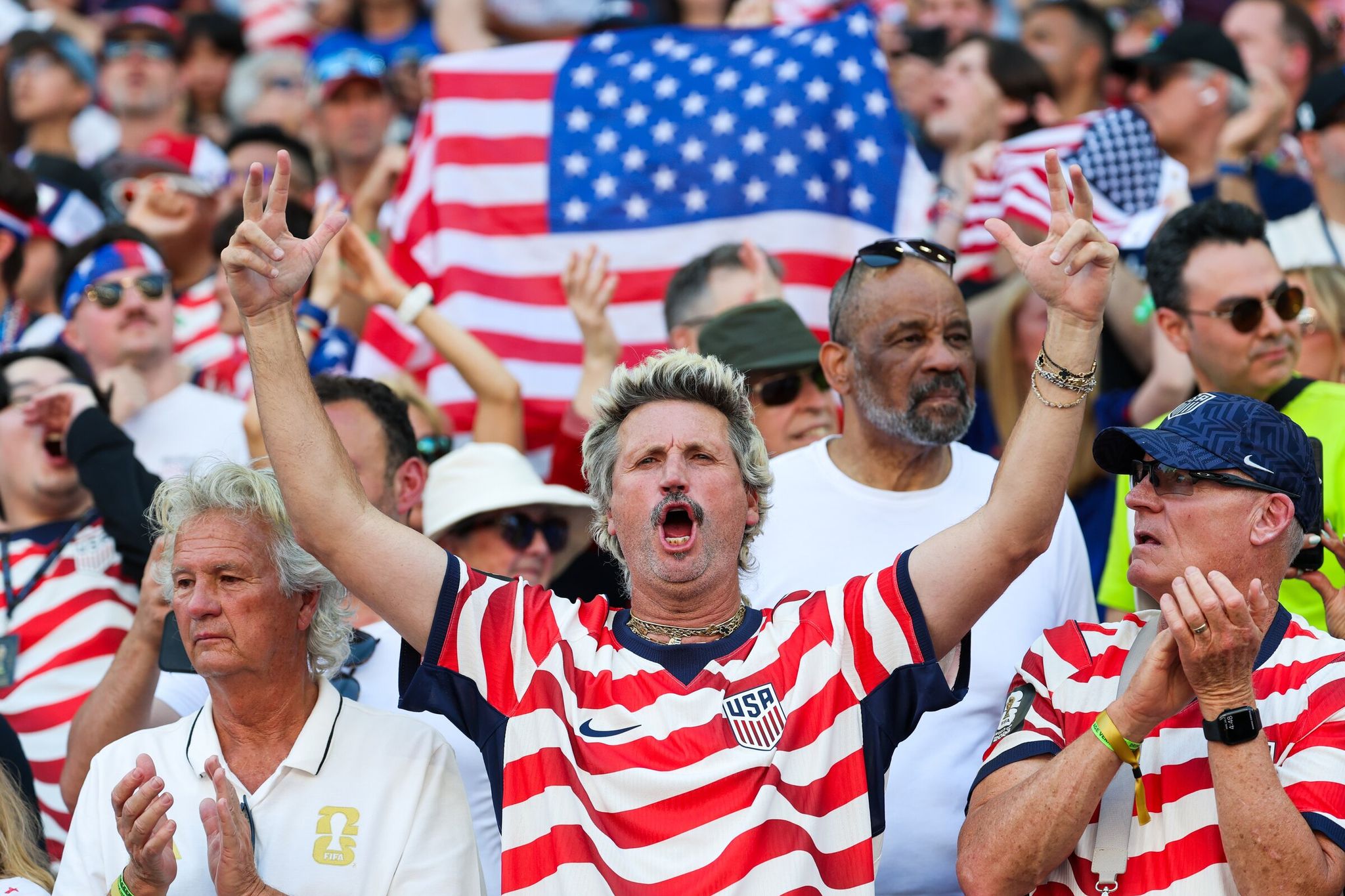A fan greets supporters ahead of the U.S. and Belgium men’s national teams’ match at the FIFA World Cup at Seattle’s stadium on Monday. (Dean Rutz / The Seattle Times)