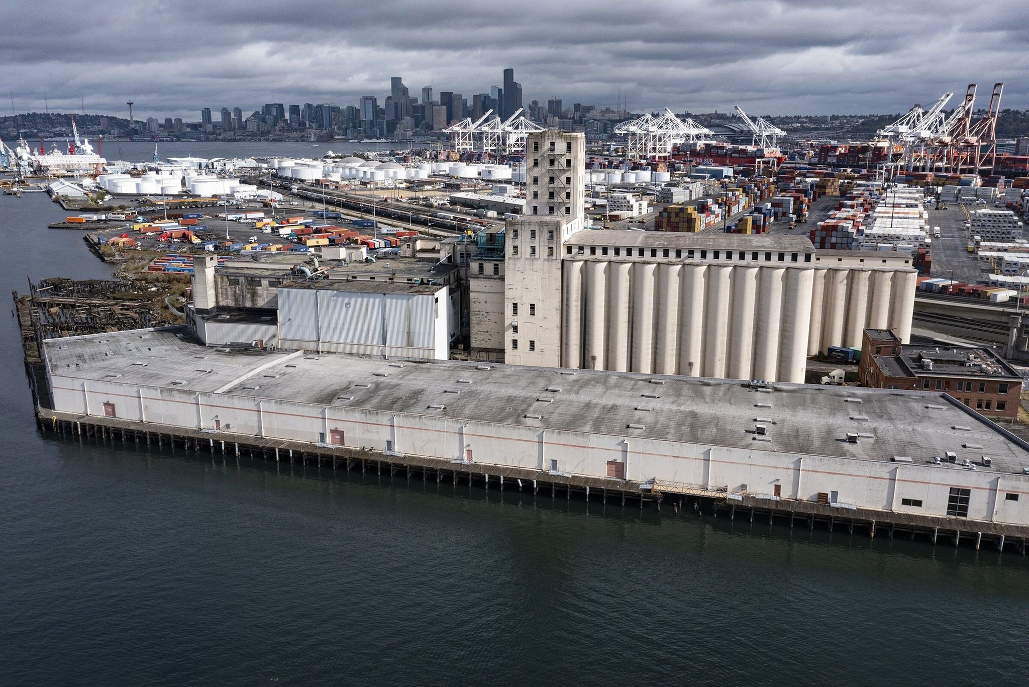 Harbor Island Studios, a low-slung building stretching along the waterfront in the foreground, photographed from the air in September 2021 in Seattle. (Ken Lambert / The Seattle Times)