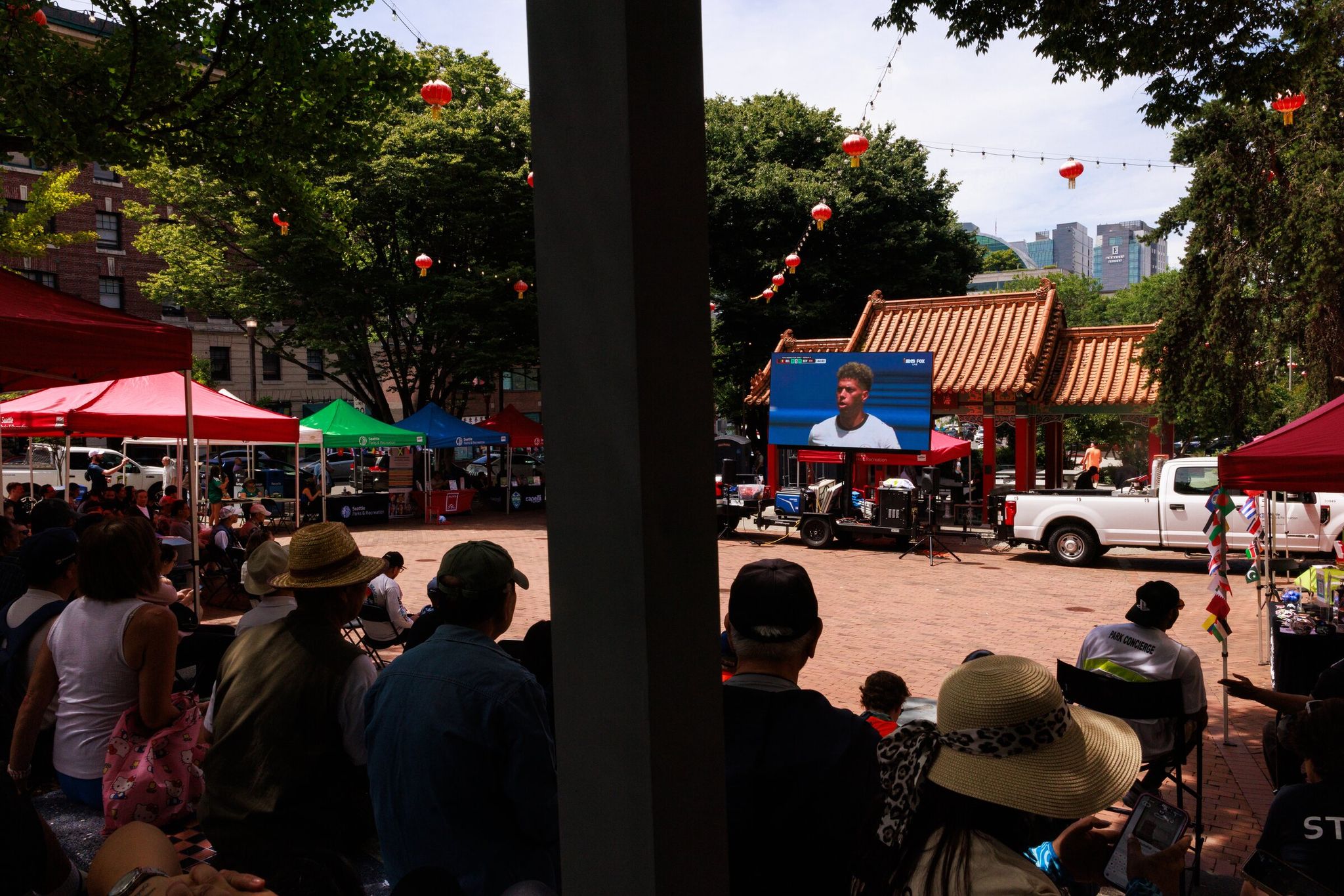 Fans watch the World Cup match Belgium vs. Egypt at Hing Hay Park in the Chinatown-International District neighborhood in Seattle on Monday. (Erika Schultz / The Seattle Times)