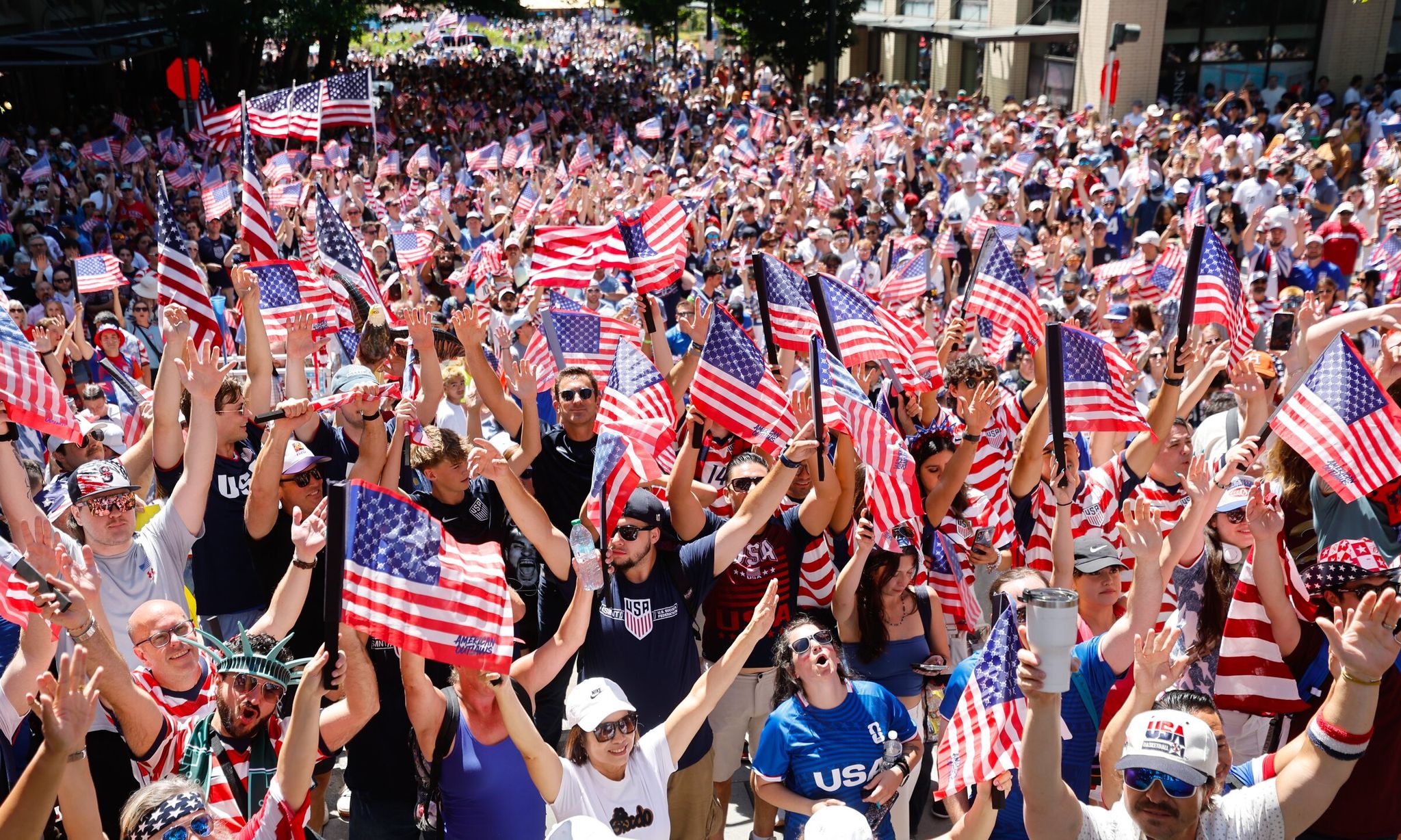Soccer fans gather at the dock stairs before their march to the round of 16 World Cup match between the USA and Belgium in Seattle on Monday. (Karen Ducey / The Seattle Times)