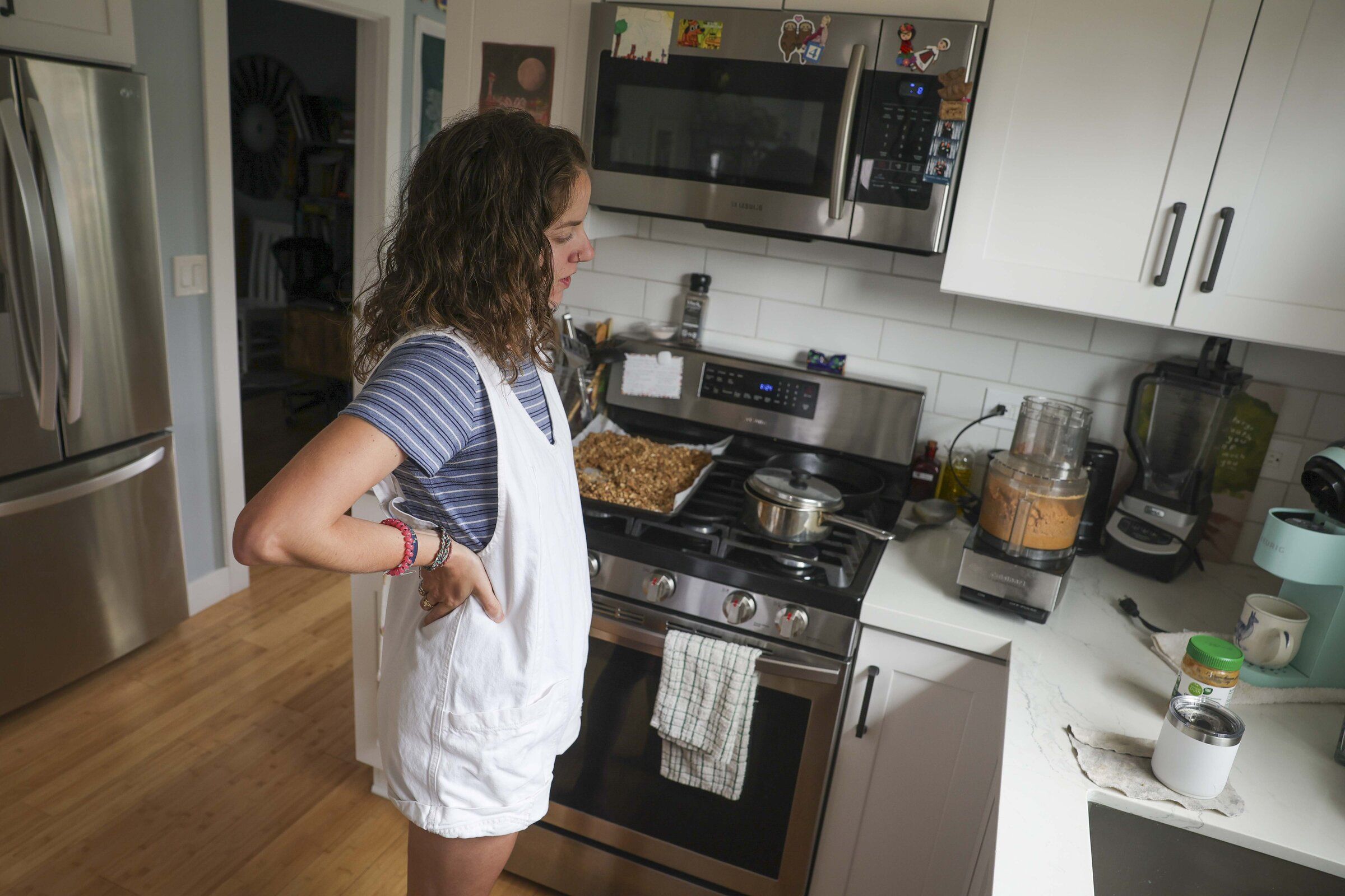 Matty Gottbrath watches as she makes peanut butter from scratch at home in Seattle on Saturday, June 27, 2026. (Ivy Sibollo / The Seattle Times)