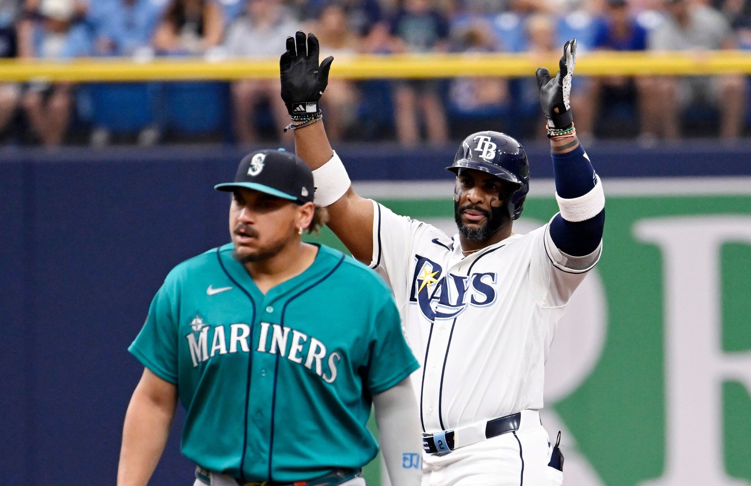Seattle Mariners first baseman Josh Naylor, left, walks back to first as Tampa Bay Rays’ Yandy DÃaz, right, celebrates after hitting a double during the third inning of a baseball game Saturday, July 11, 2026, in St. Petersburg, Fla. (Jason Behnken / AP)