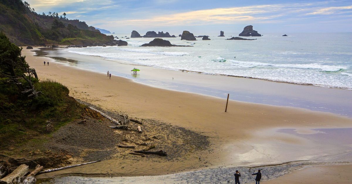 Sand is burying their Cannon Beach home. Oregon won’t let them remove it