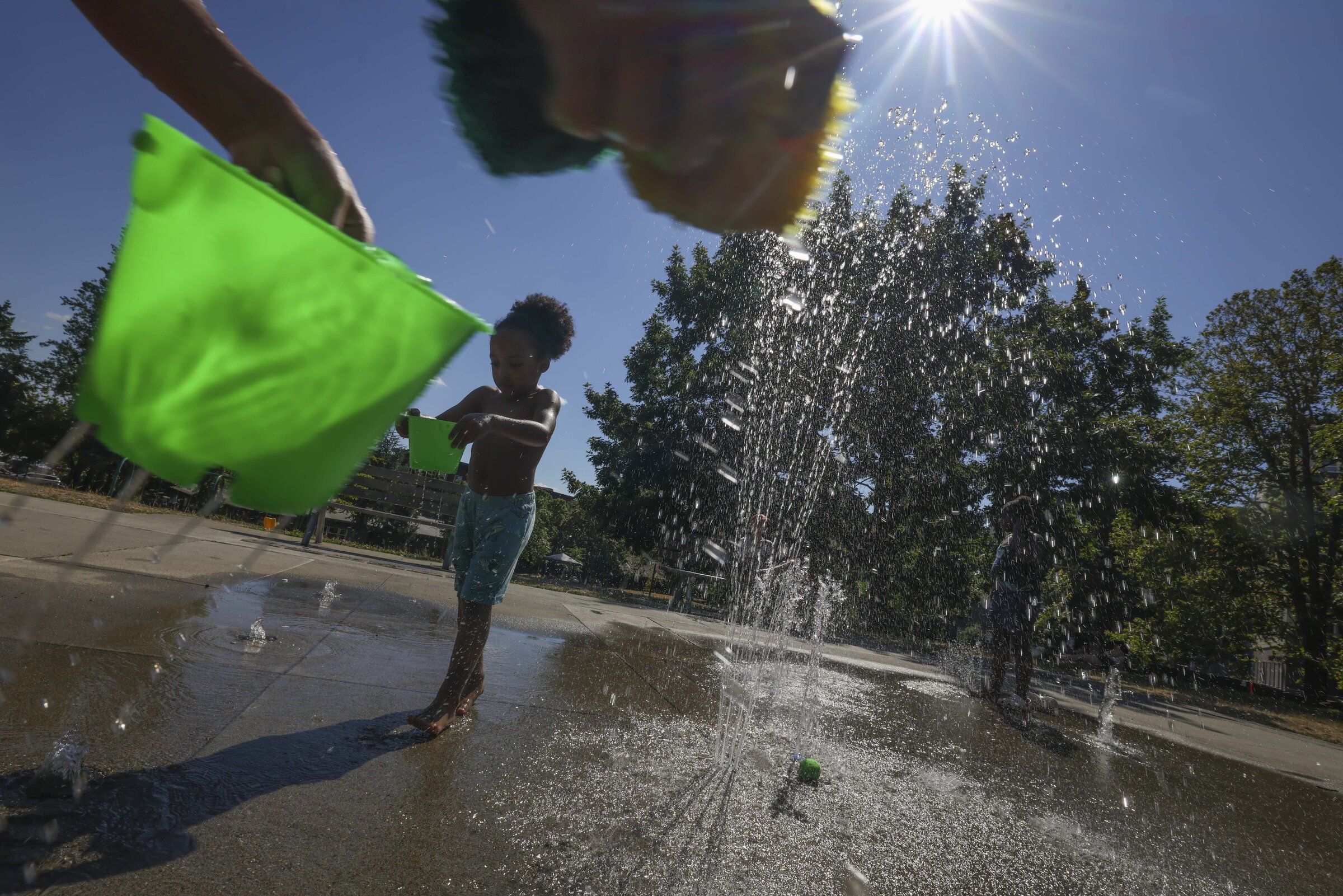 La’Ray Rogers Jr., 4, plays at Pratt Park’s spray park in Seattle on Saturday. (Ivy Ceballo / The Seattle Times)